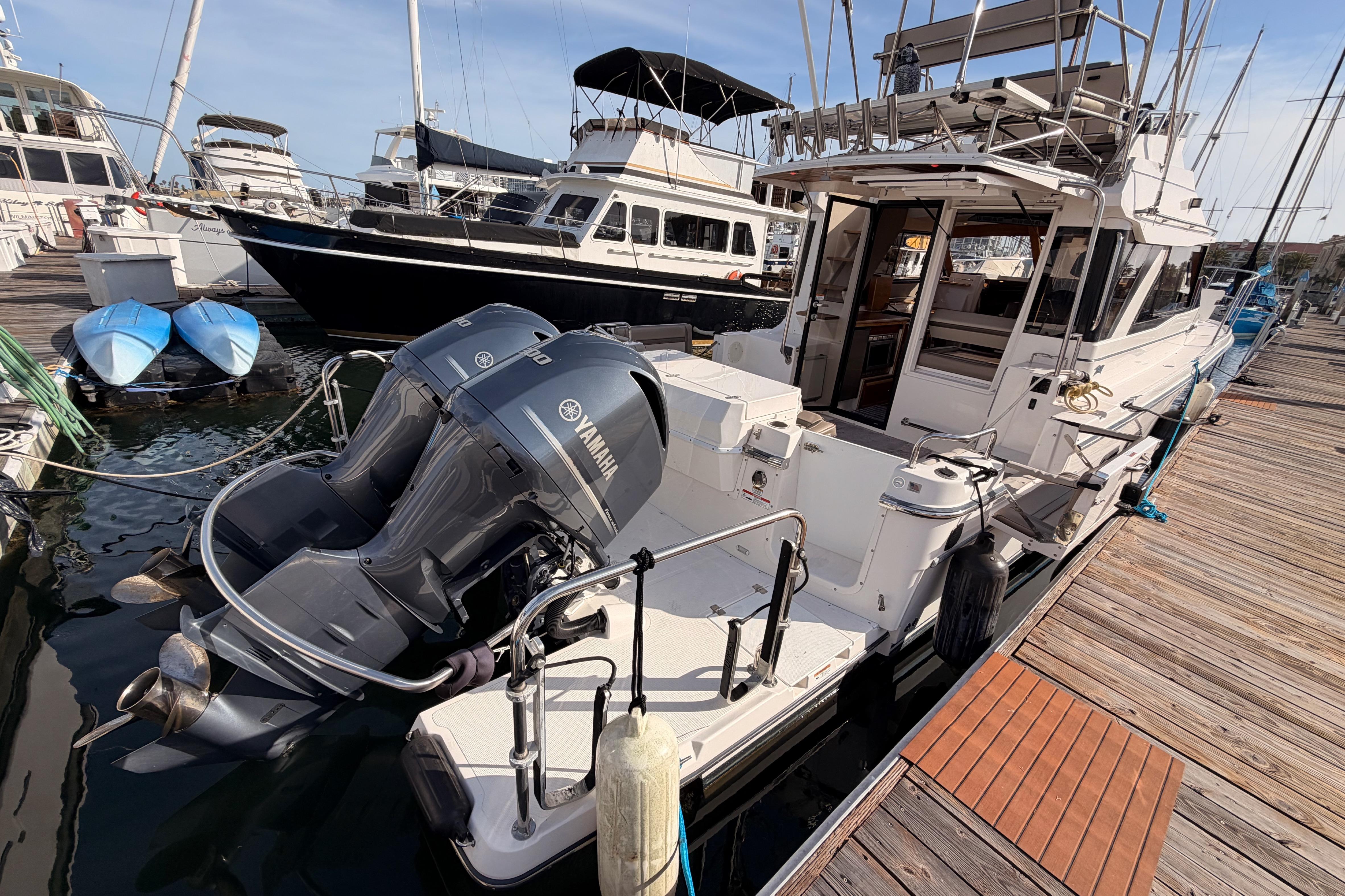 2021 Cutwater C-32 CB boat docked with Yamaha outboard engines, marina setting.