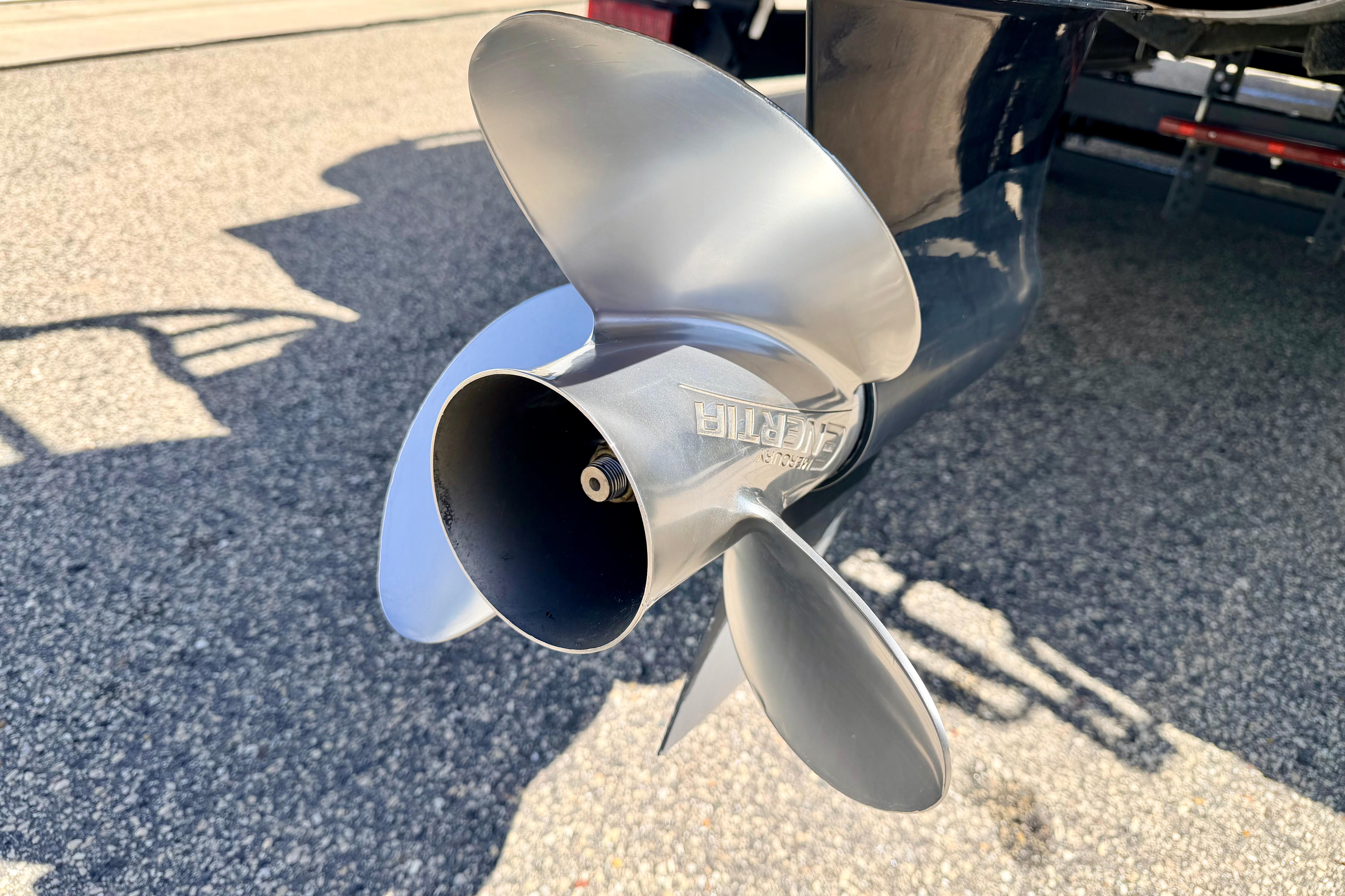 Close-up of a 2019 Crestliner 240 Rally DX CW boat propeller on pavement.