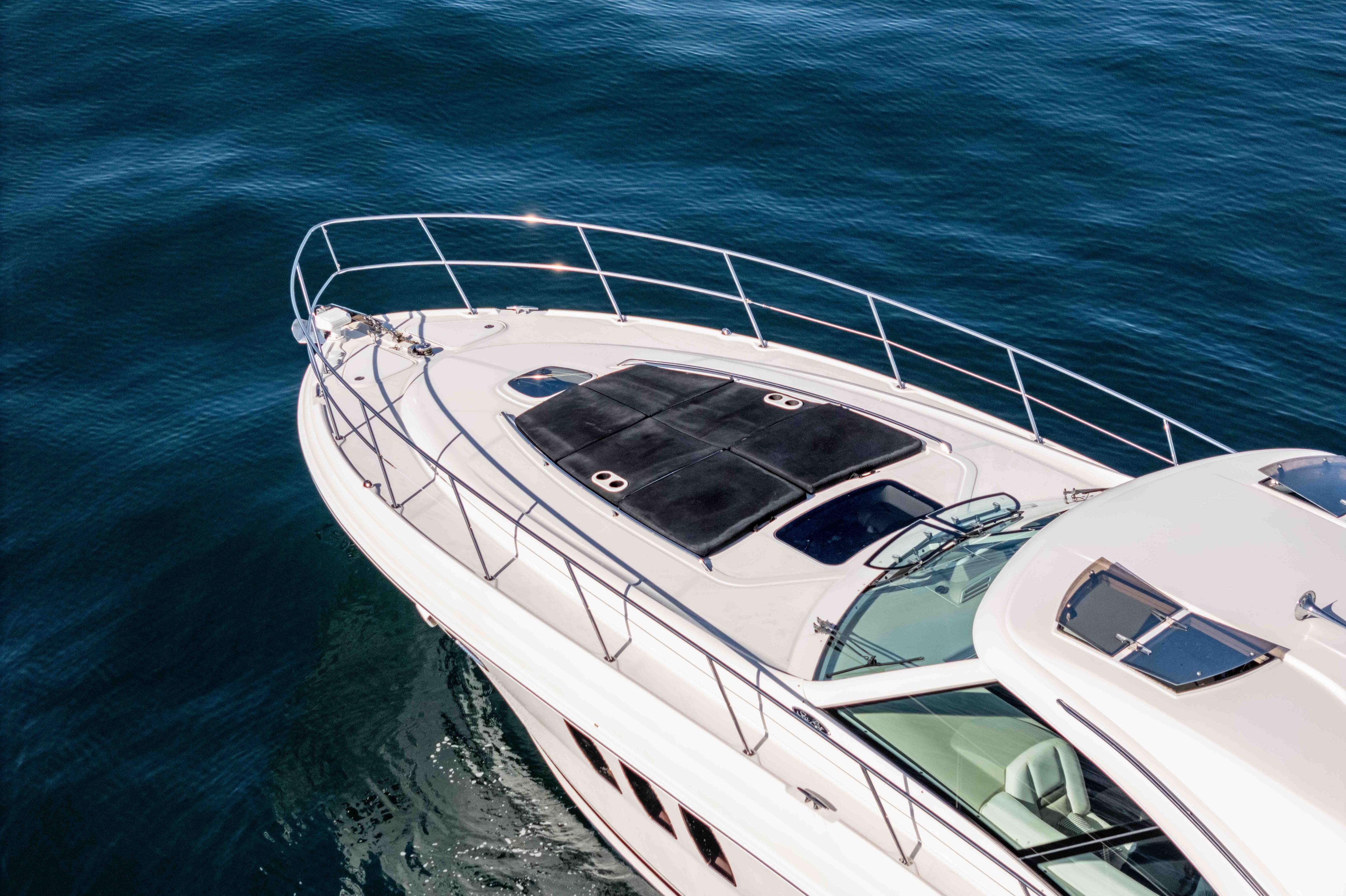 2007 Sea Ray 48 Sundancer yacht cruising on calm blue waters.