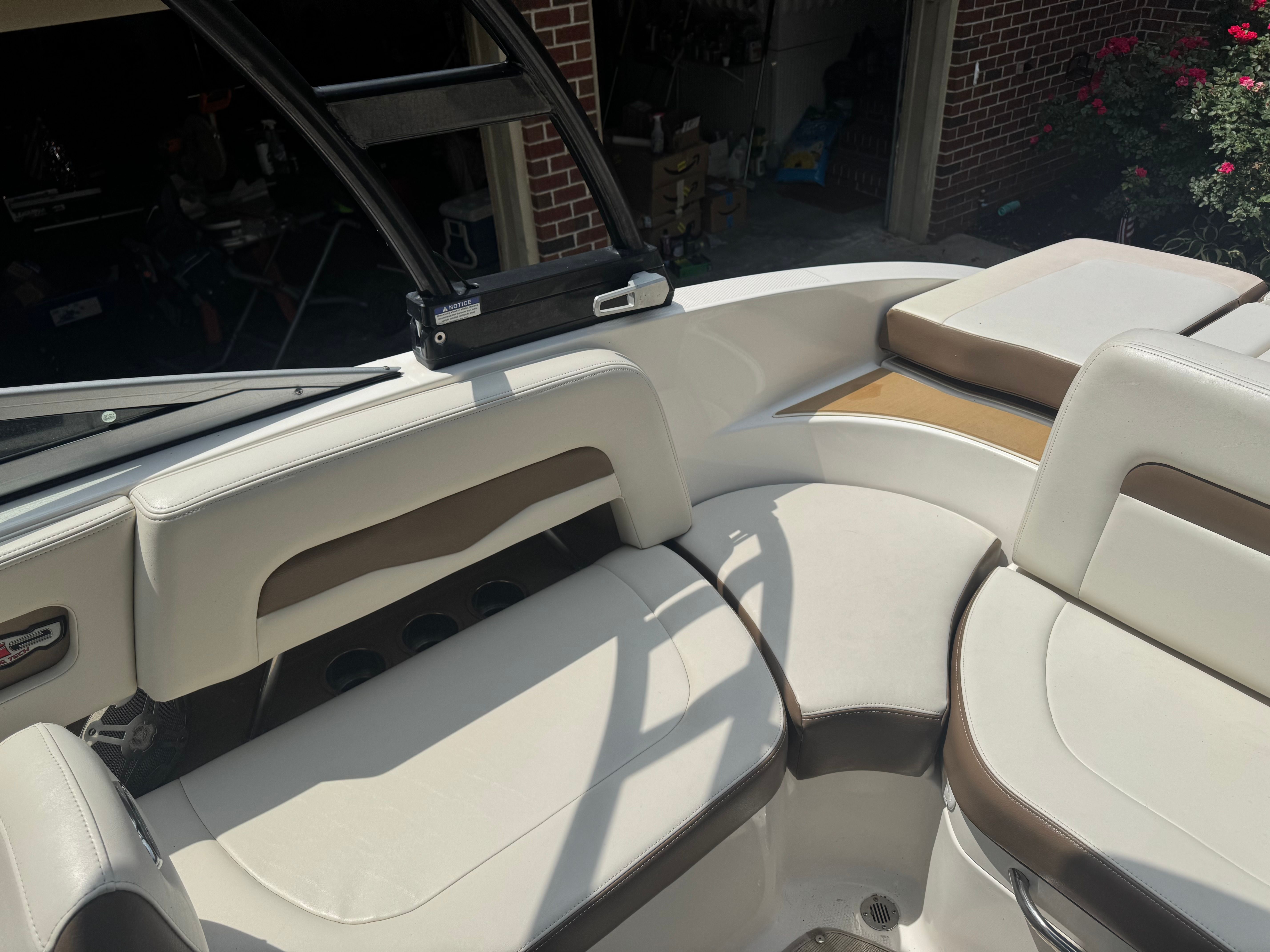 Interior of a 2016 Chaparral 246 SSi boat with beige seating.