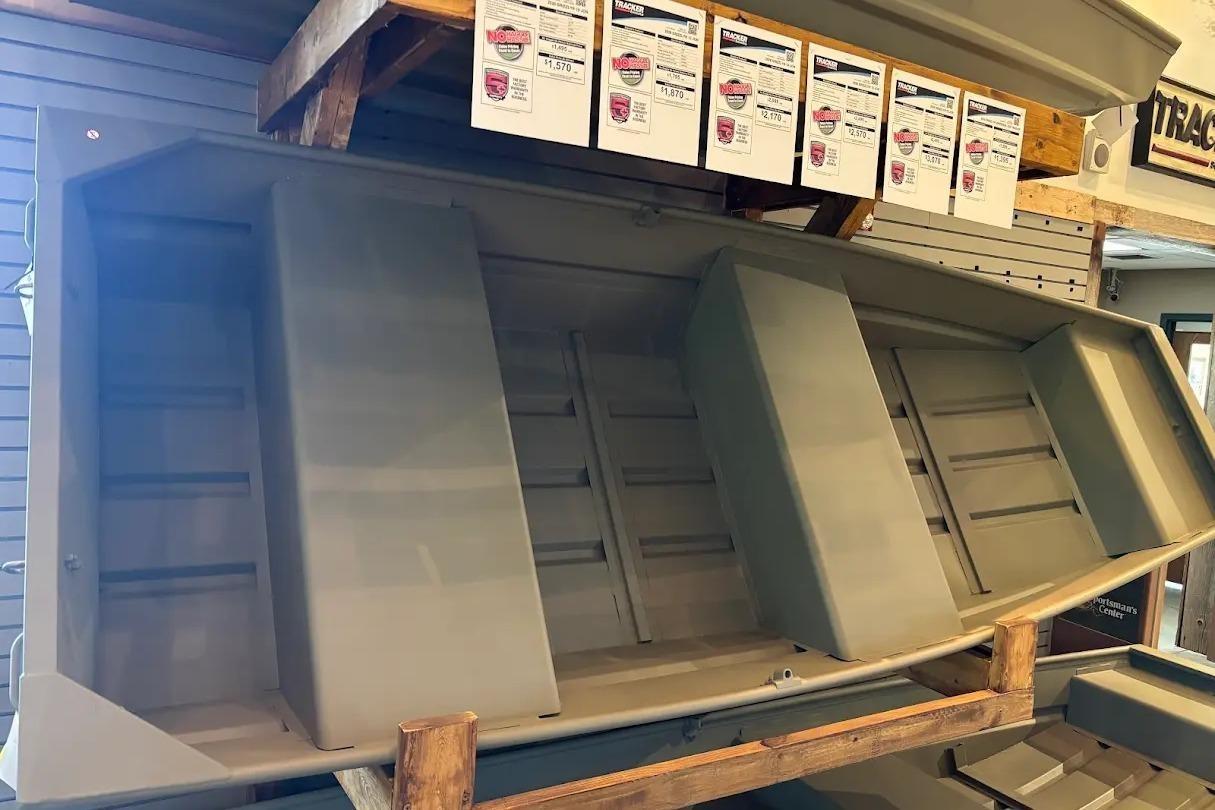 2026 Tracker Grizzly 12 Jon boat displayed in a showroom, showcasing its sturdy design.