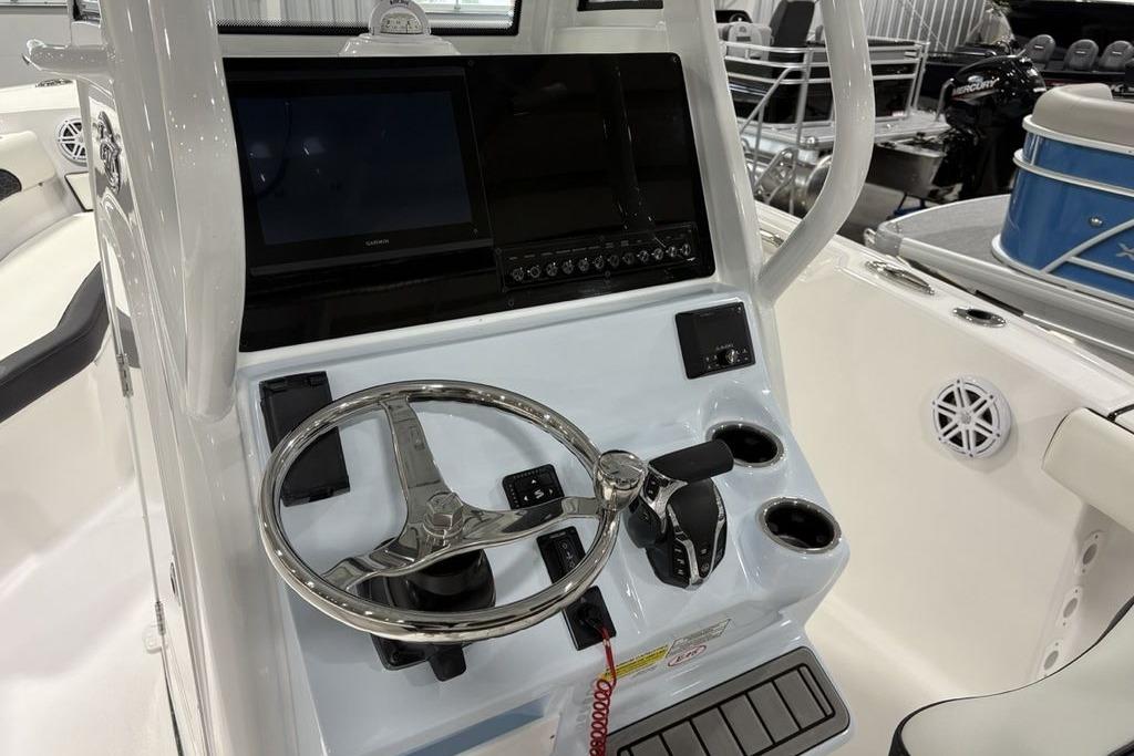 2026 Tidewater 232 CC Adventure boat console with steering wheel and controls.