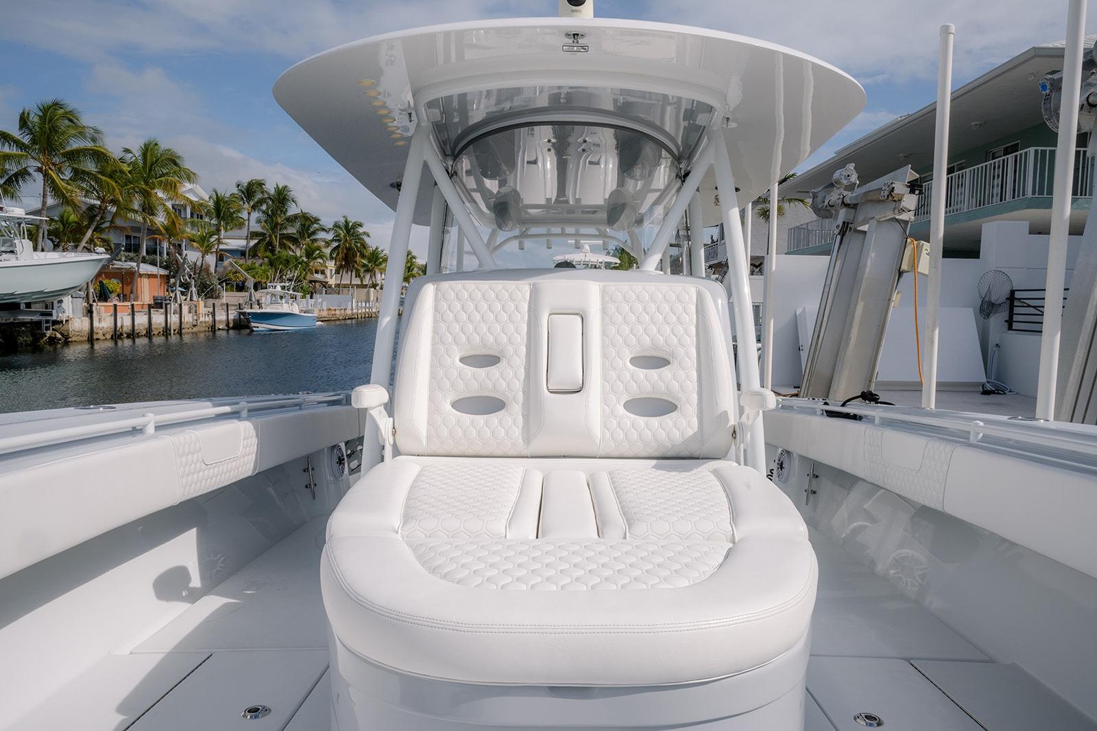 2024 Contender 44 ST boat with luxurious white seating, docked near palm trees.