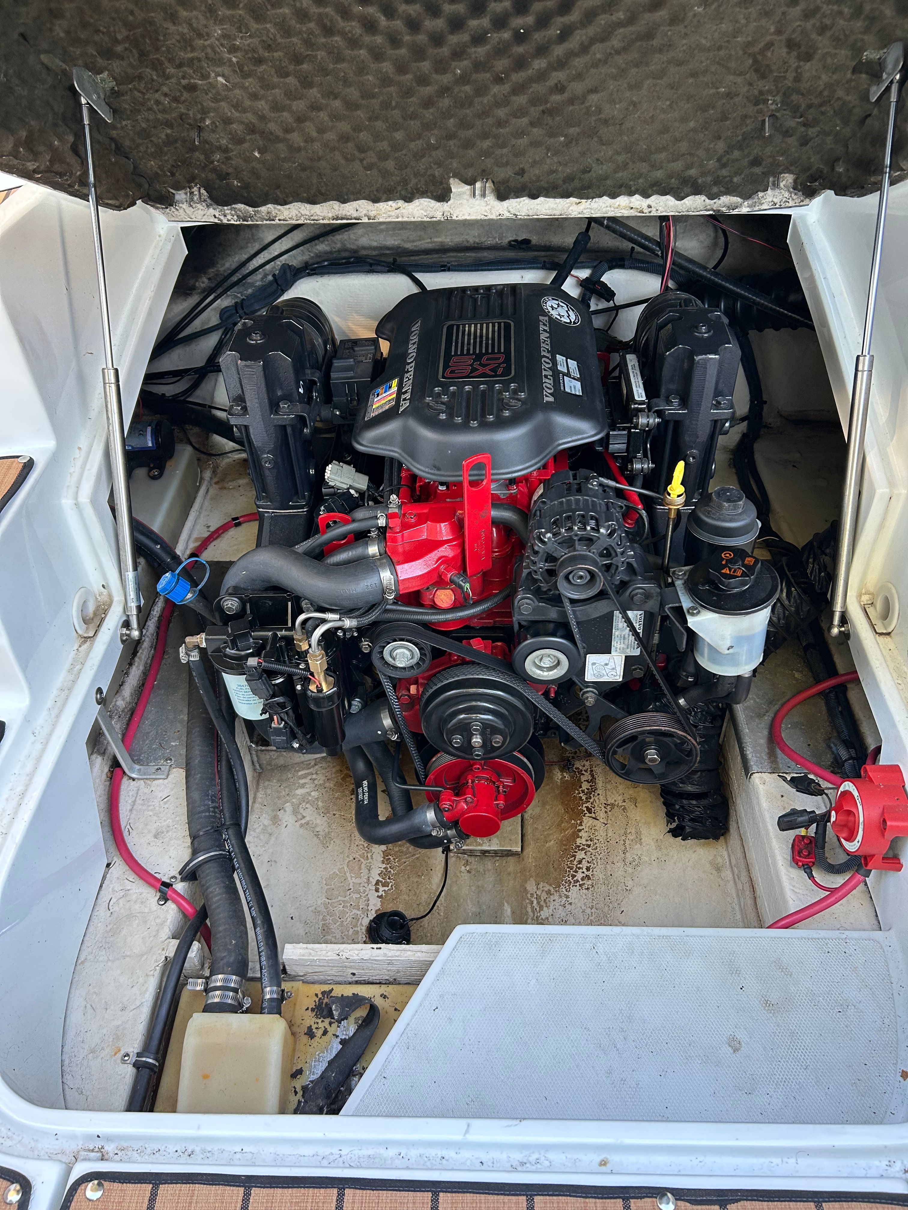 The engine compartment of a 2008 Azure AZ220 boat shows a well-maintained engine with red accents.
