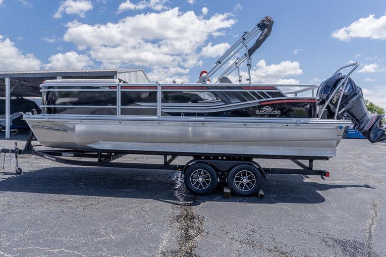 2026 SunCatcher Select 322SL pontoon boat on trailer under a blue sky.