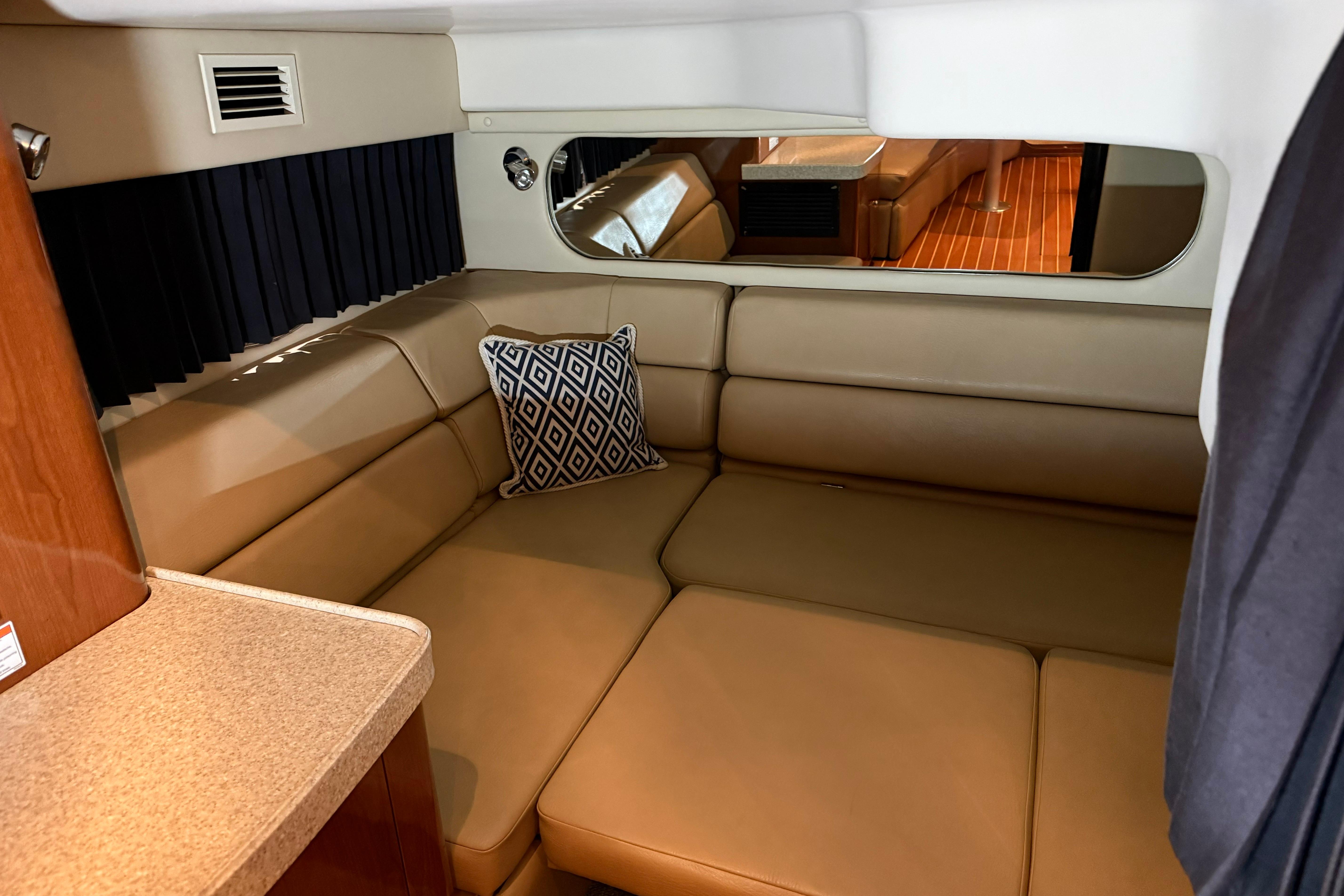 2007 Regal Commodore 3760 IO interior with beige seating and decorative pillow.