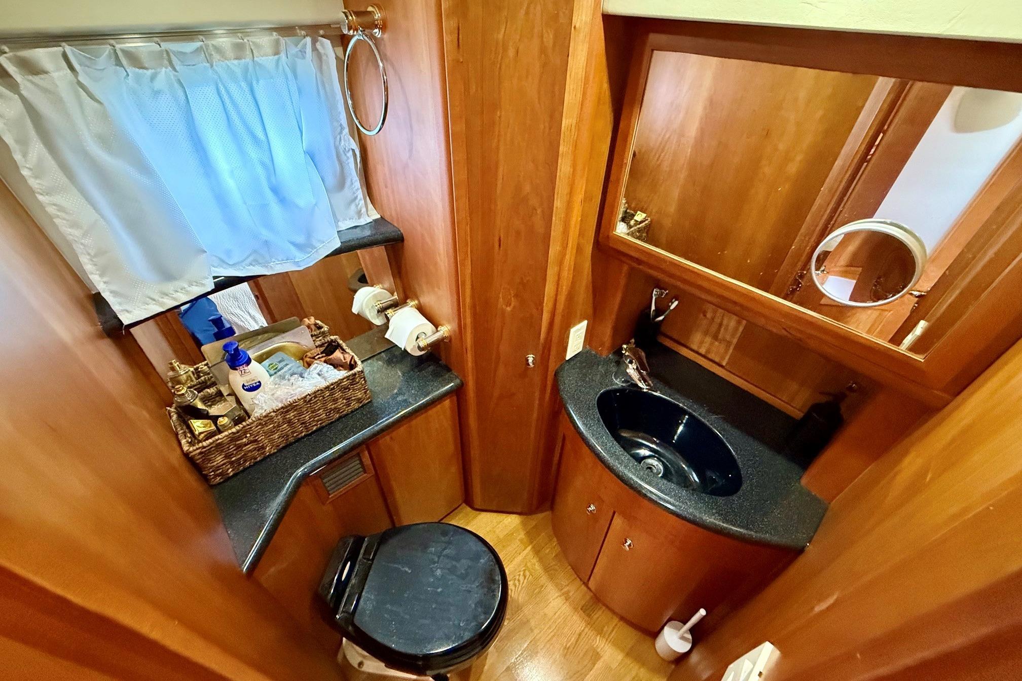 Luxurious bathroom in 2004 Silverton 39 Motor Yacht with wood accents and modern amenities.