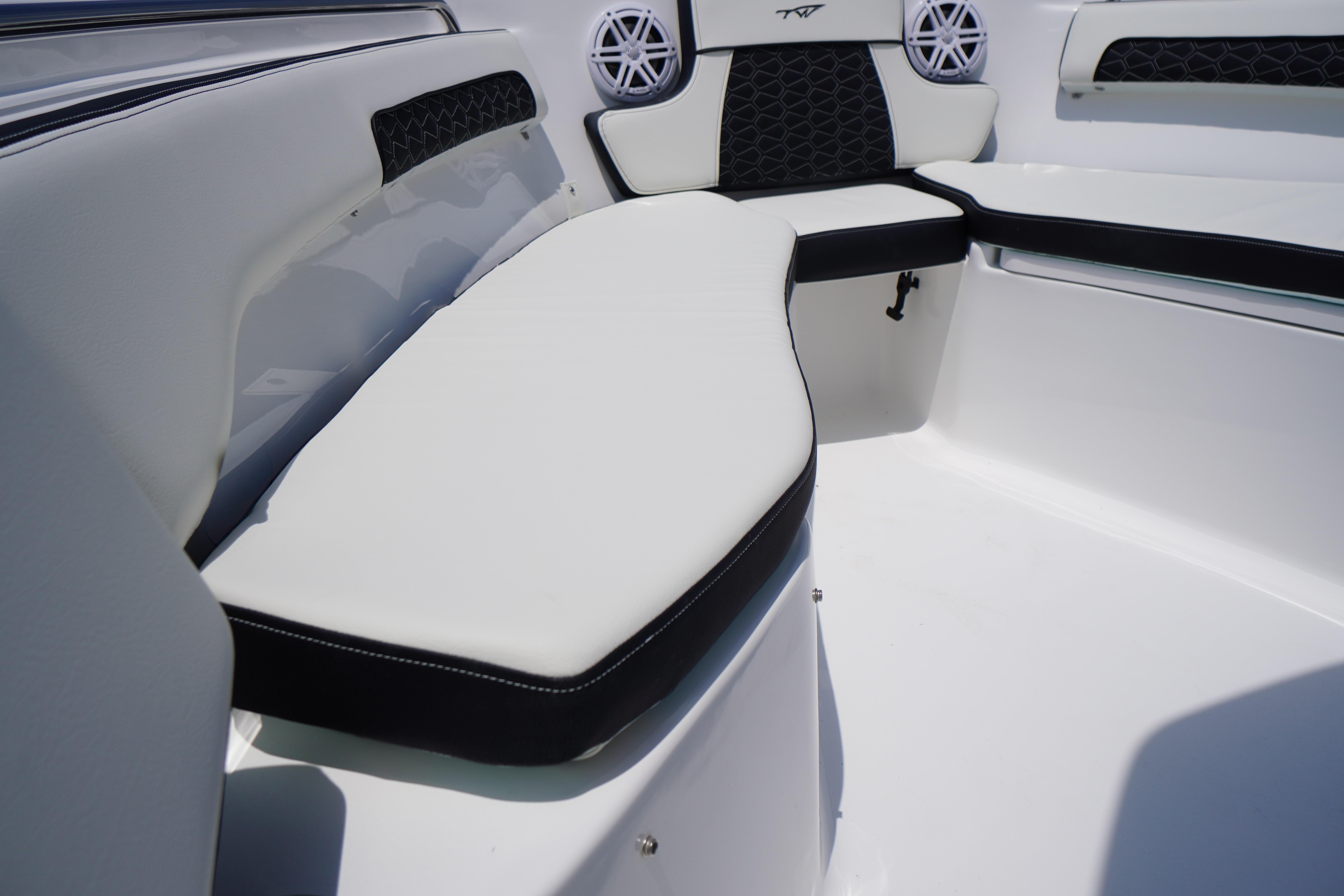 Interior seating of 2027 Tidewater 220 CC Adventure boat, featuring sleek white and black design.