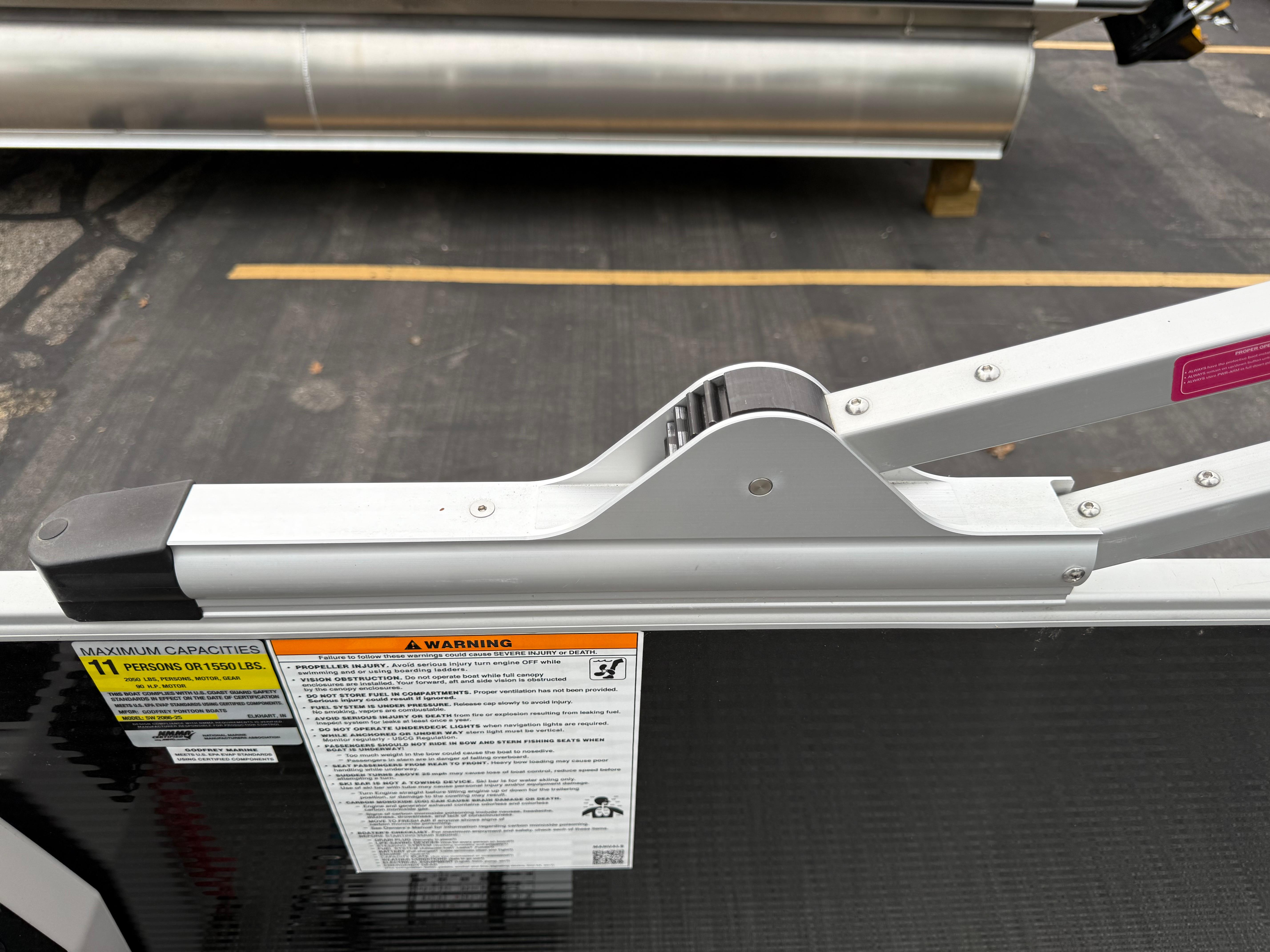 2023 Godfrey Sweetwater boat detail showing capacity and warning labels.