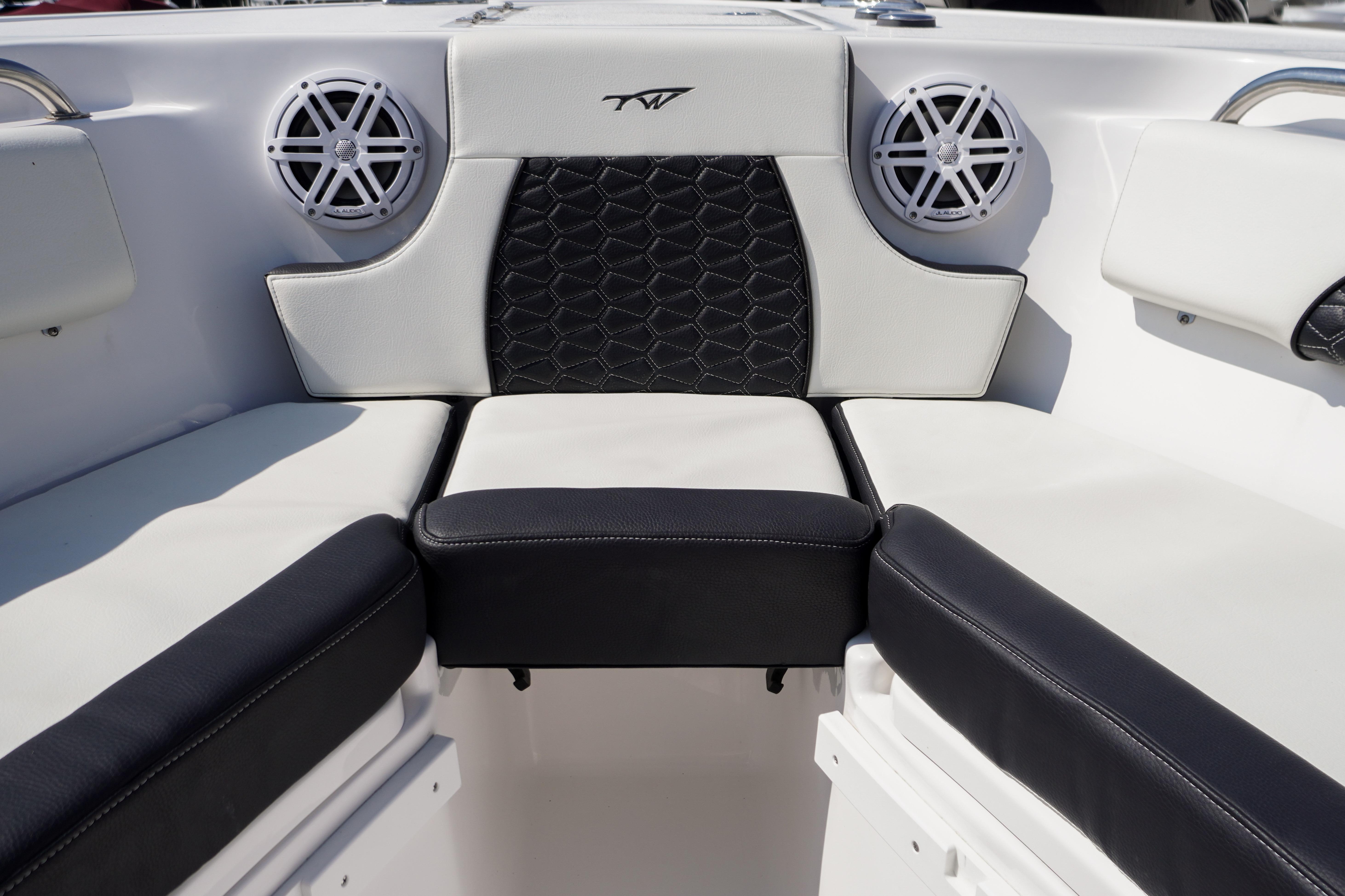 2025 Tidewater 232 SS boat interior with cushioned seating and built-in speakers.