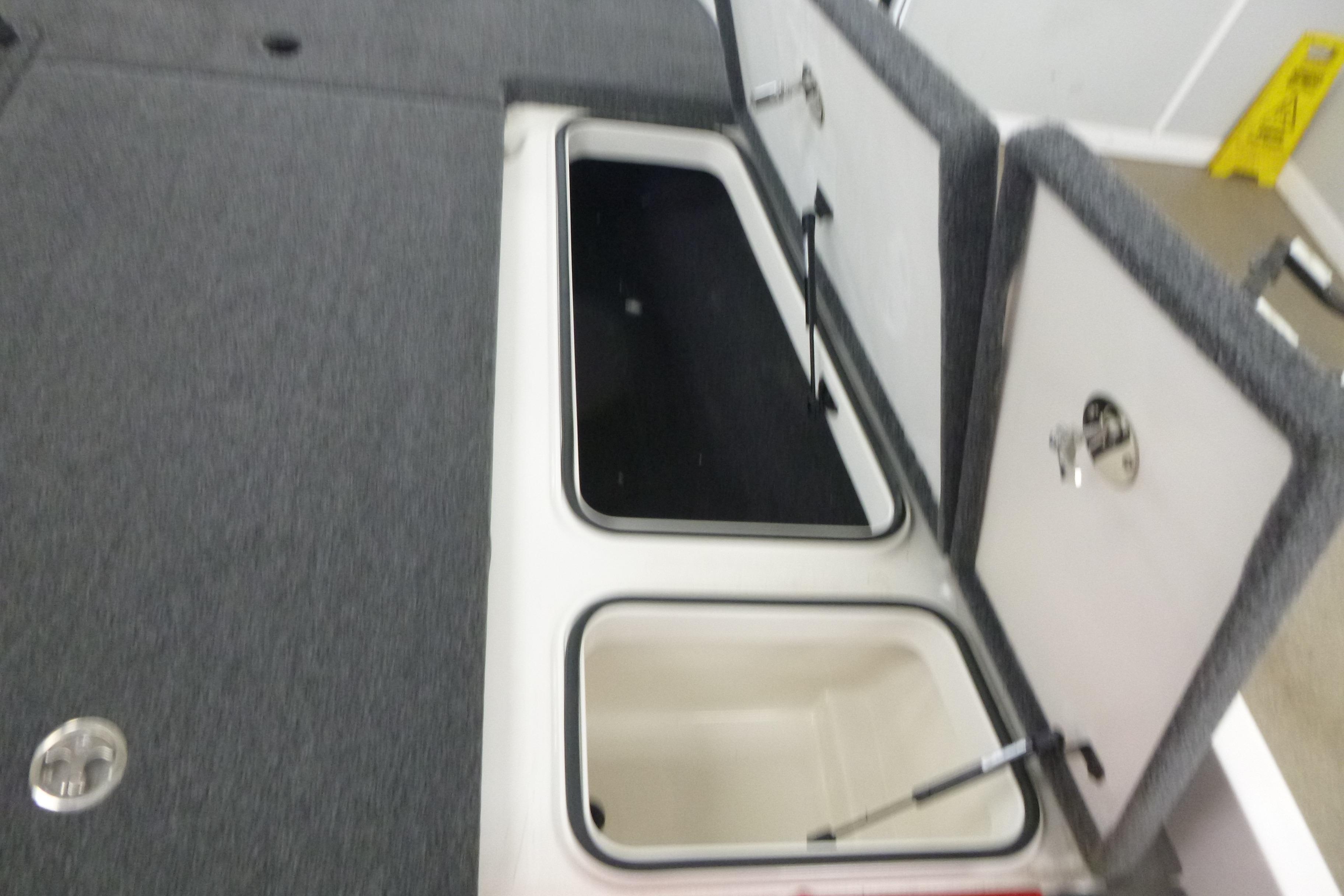 2025 Ranger Z185 boat storage compartments with open lids, showcasing interior space.