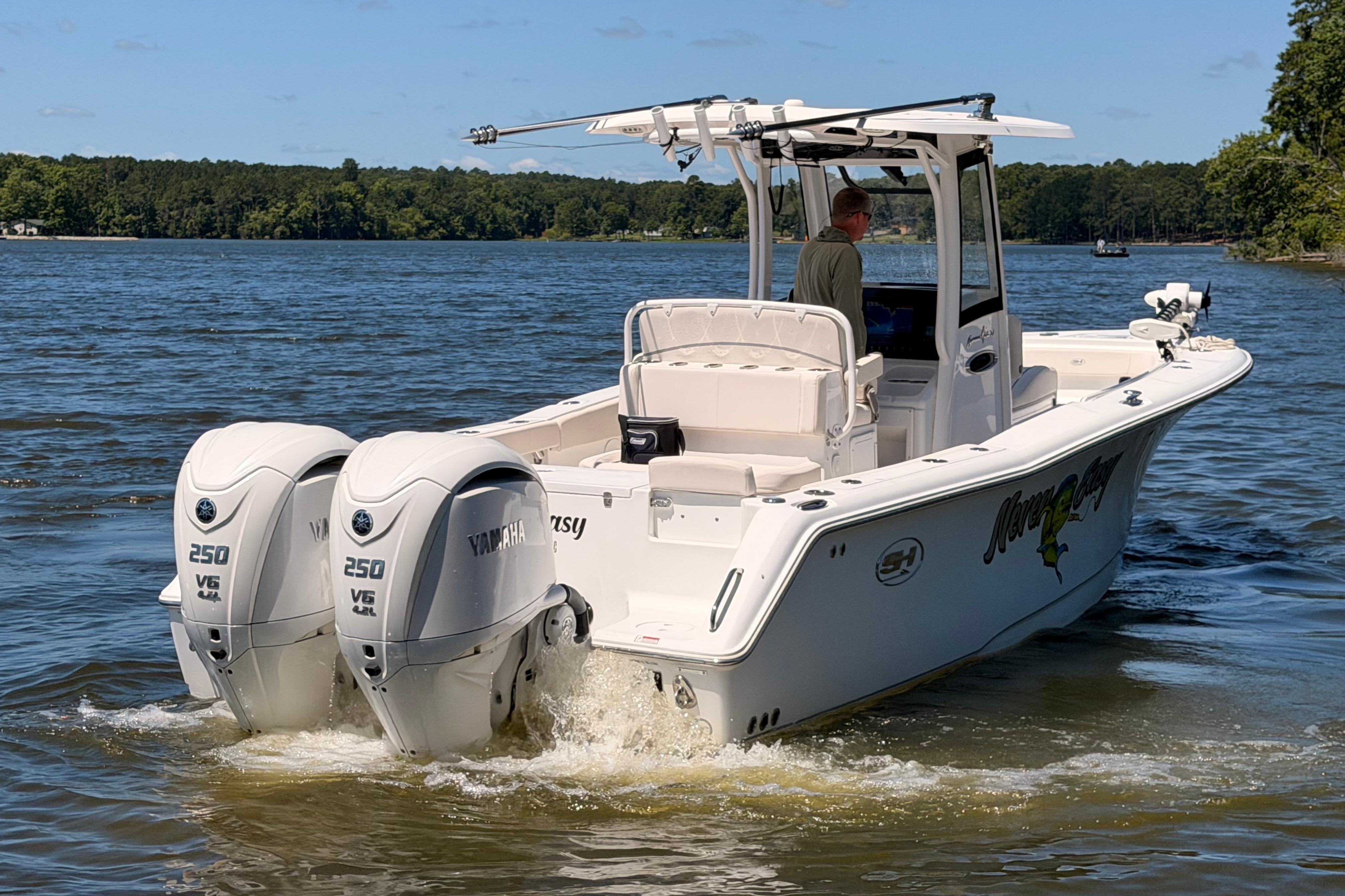 2024 Sea Hunt Gamefish 27 Coffin Box boat with twin Yamaha 250 V6 engines on a lake.