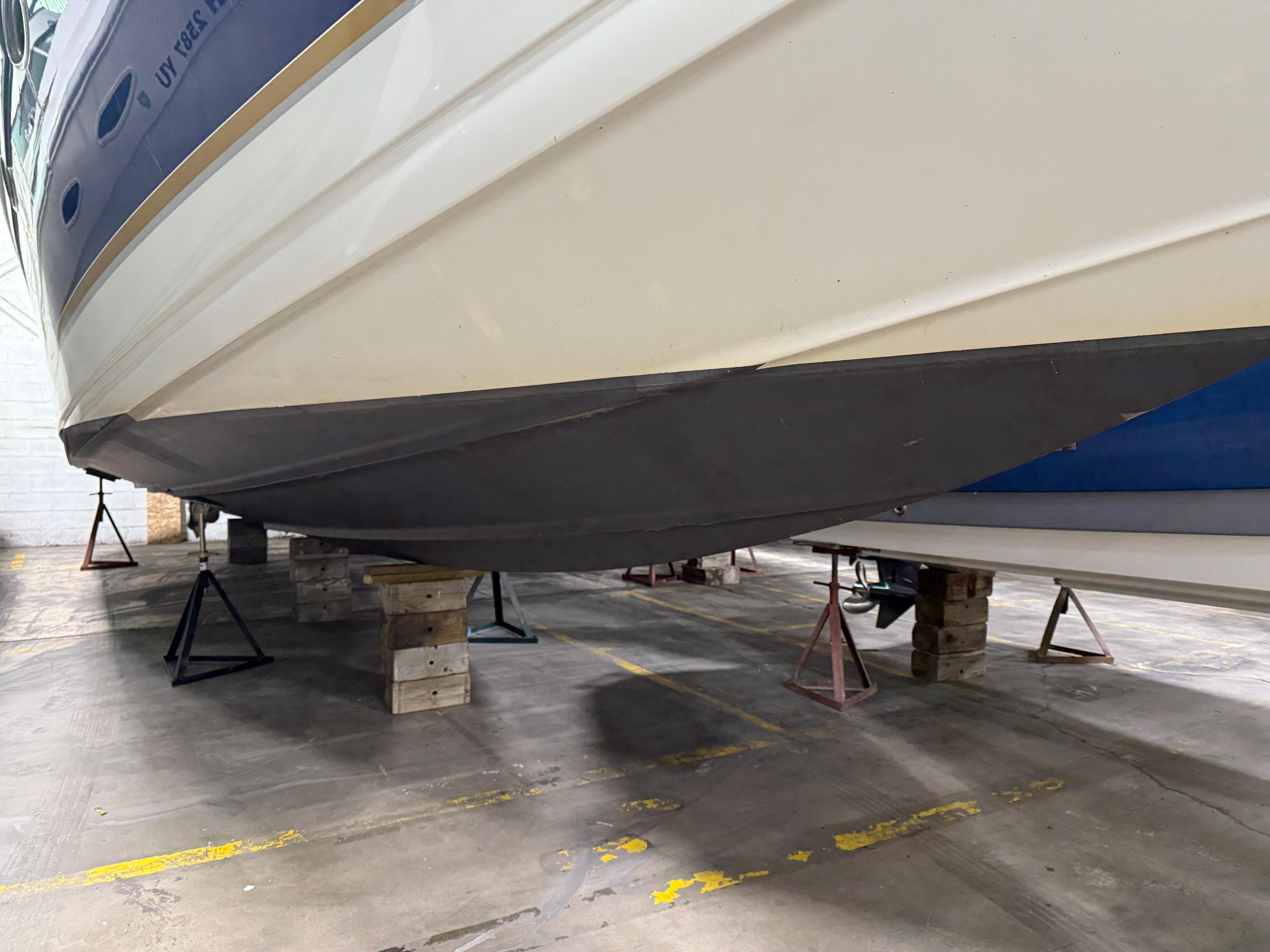 2002 Formula 400 Super Sport boat on stands in a warehouse.
