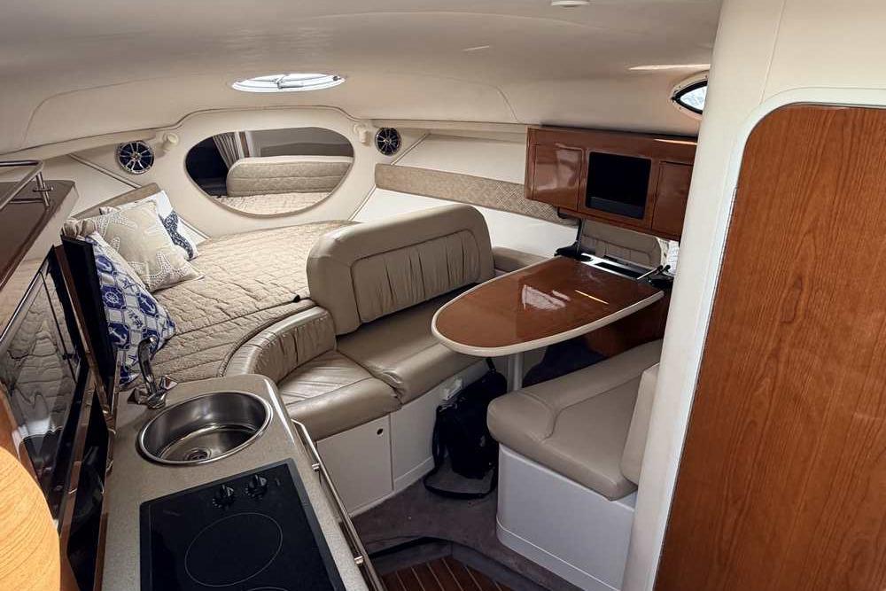 Interior of a 2001 Monterey 282 Cruiser with cozy seating, kitchenette, and sleeping area.