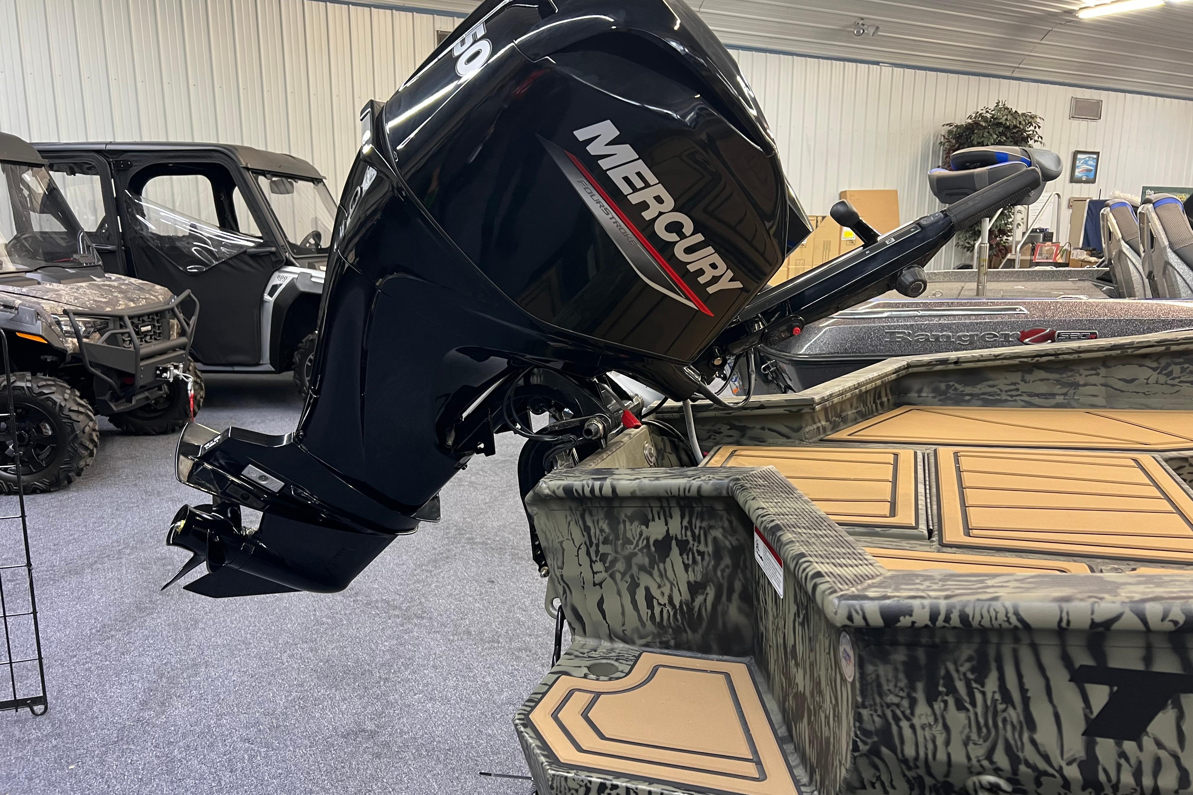 2026 Tracker Grizzly 1650 T Prairie Wings Edition with Mercury outboard motor in showroom.