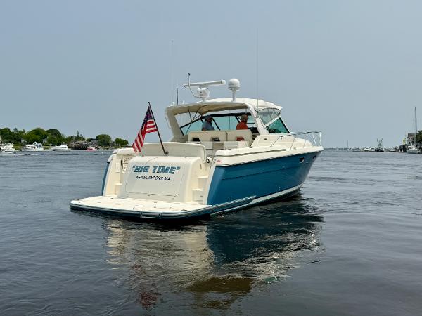 1996 Tiara Yachts 3500 Express on calm water with US flag.