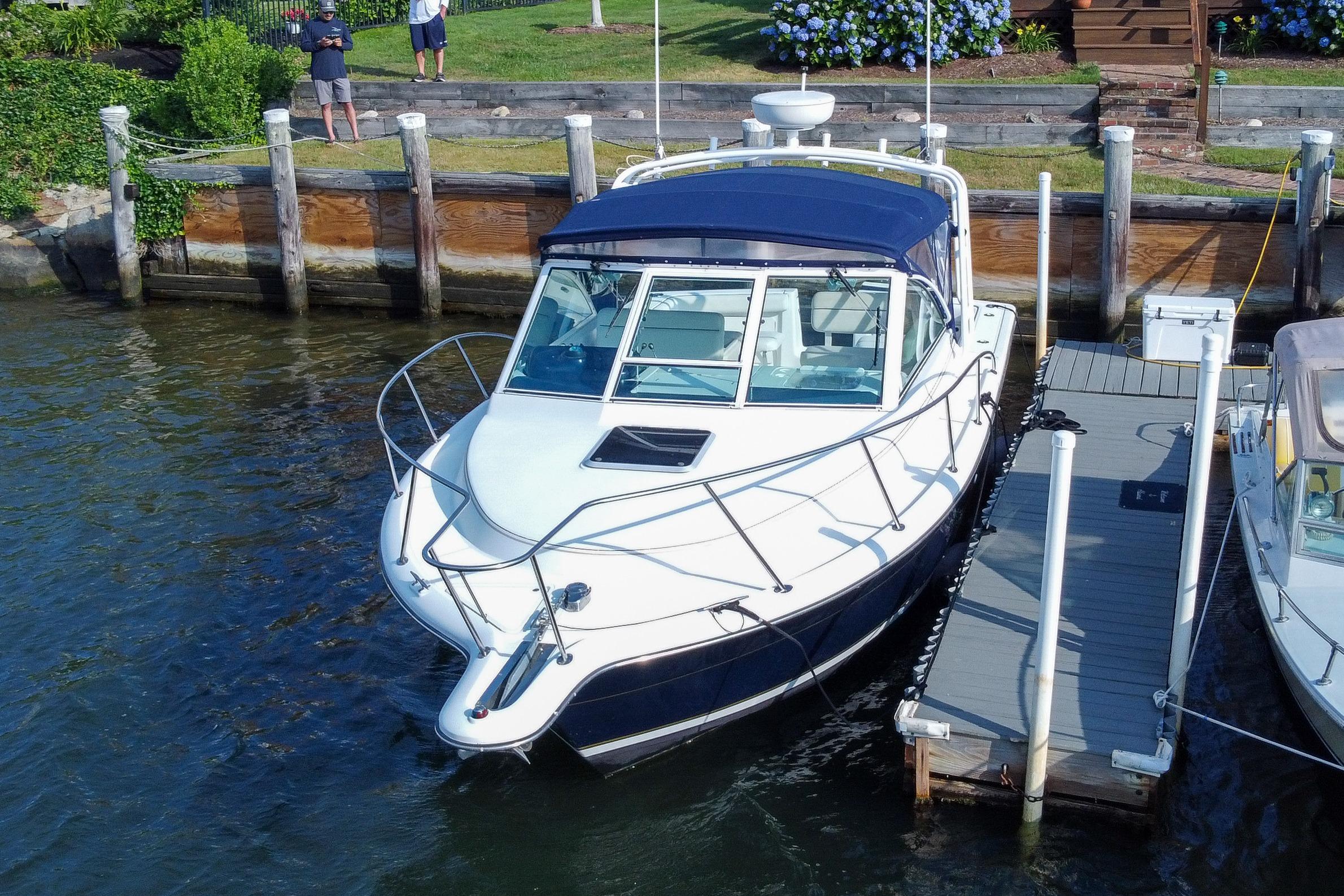 2001 Tiara Yachts 2900 Coronet docked at a marina, featuring sleek design and blue canopy.