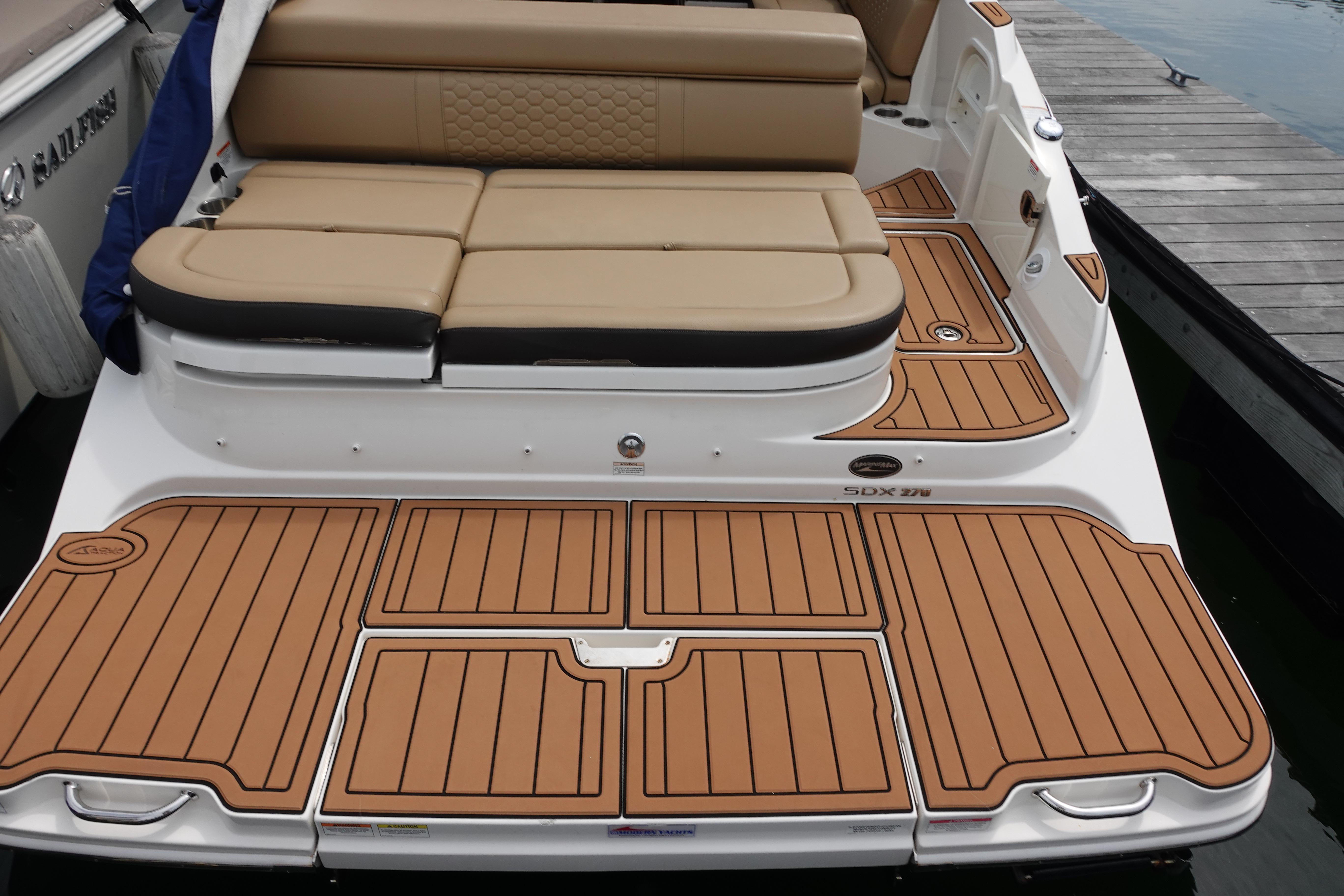 2018 Sea Ray SDX 270 boat with tan seating and teak-style deck.