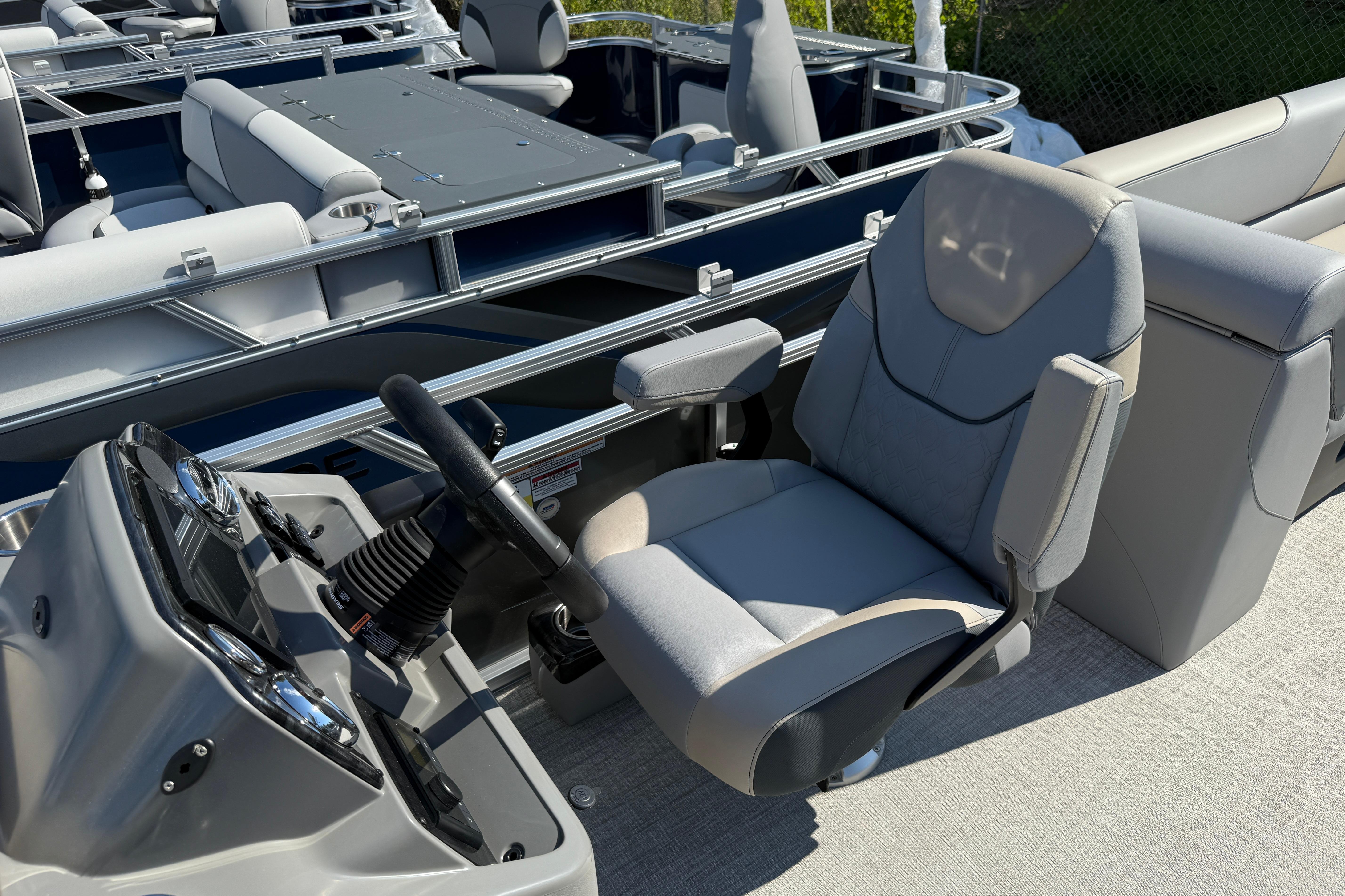 2026 Tahoe Pontoon Sport 85 Quad Lounger interior with steering console and seating.