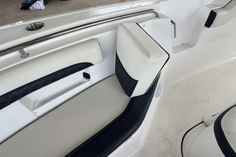 2024 Tidewater 232 LXF boat interior with cushioned seating and stainless steel details.