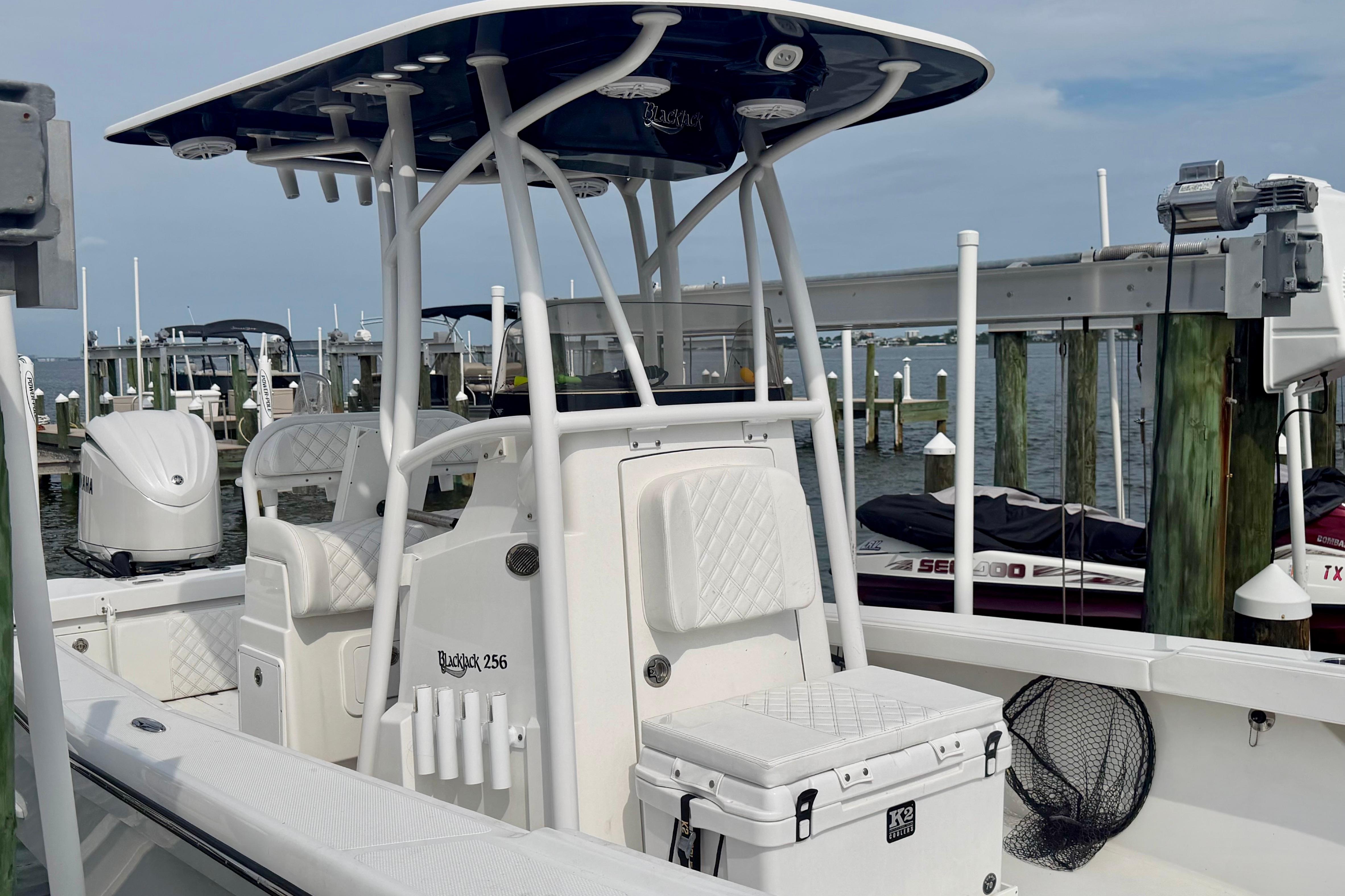 2025 BlackJack 256 Coastal boat docked at marina, featuring sleek design and modern amenities.