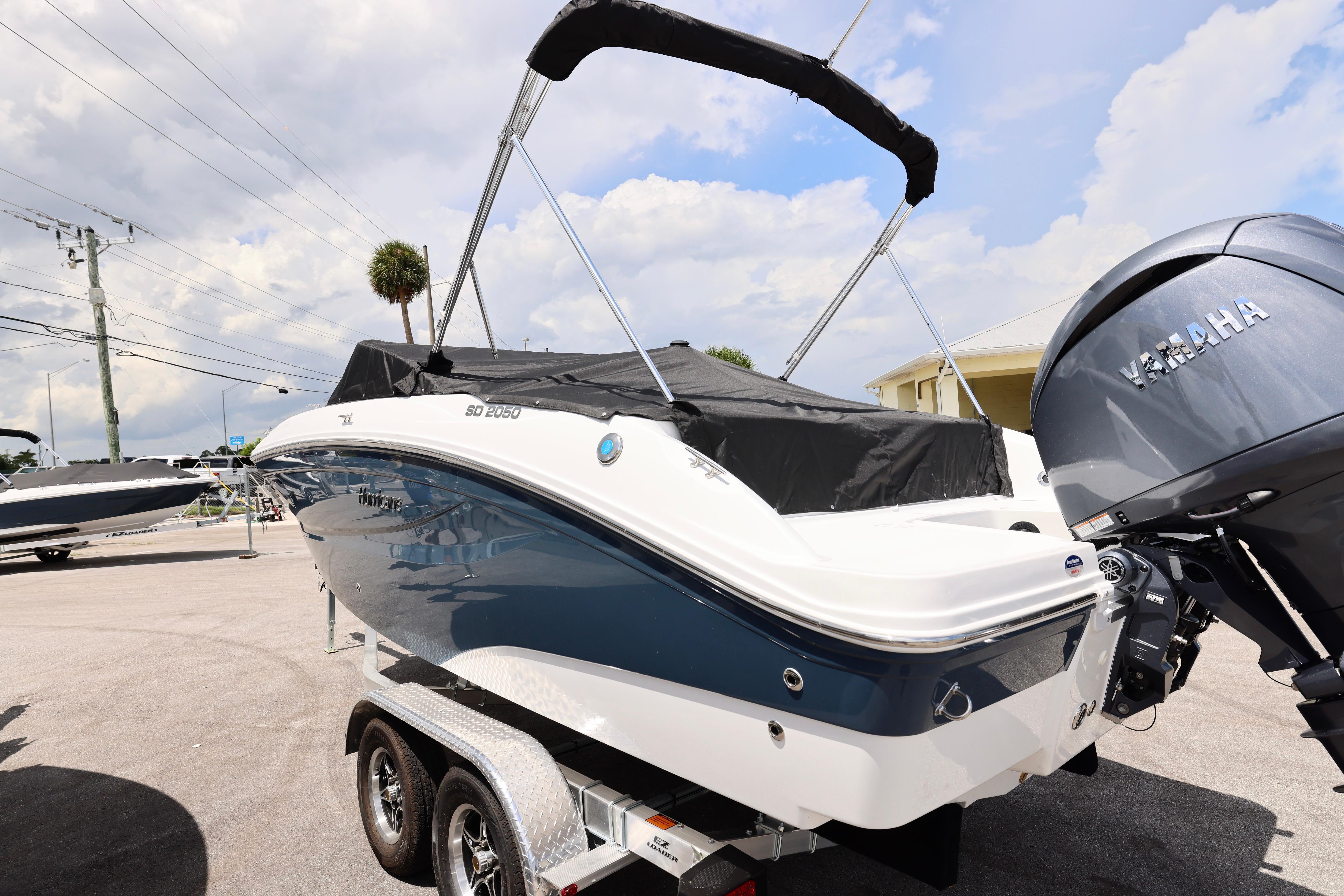 2026 Hurricane SunDeck 2050 OB boat with Yamaha outboard motor on trailer.