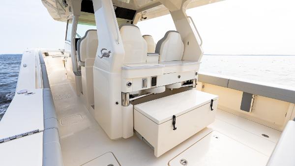 2025 Scout 425 LXF boat interior with white seating and storage, overlooking the ocean.