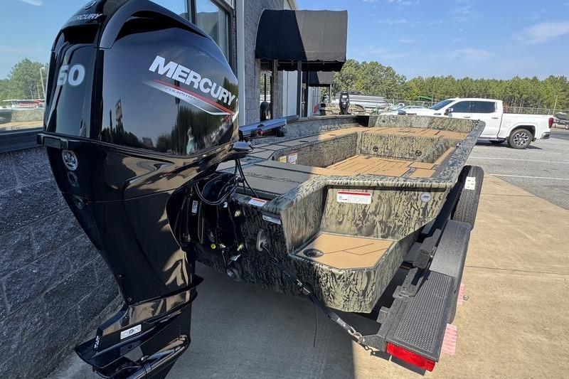 2026 Tracker Grizzly 1756 T Marsh boat with Mercury engine, parked outdoors.