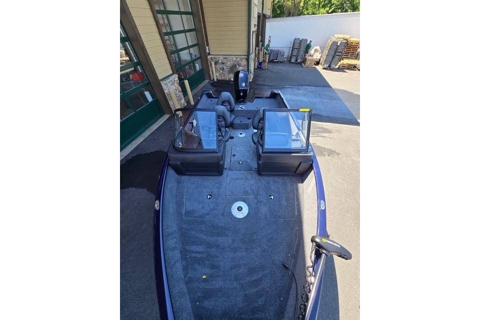 2026 Tracker Pro Guide V-175 WT boat parked outdoors, showcasing spacious interior layout.