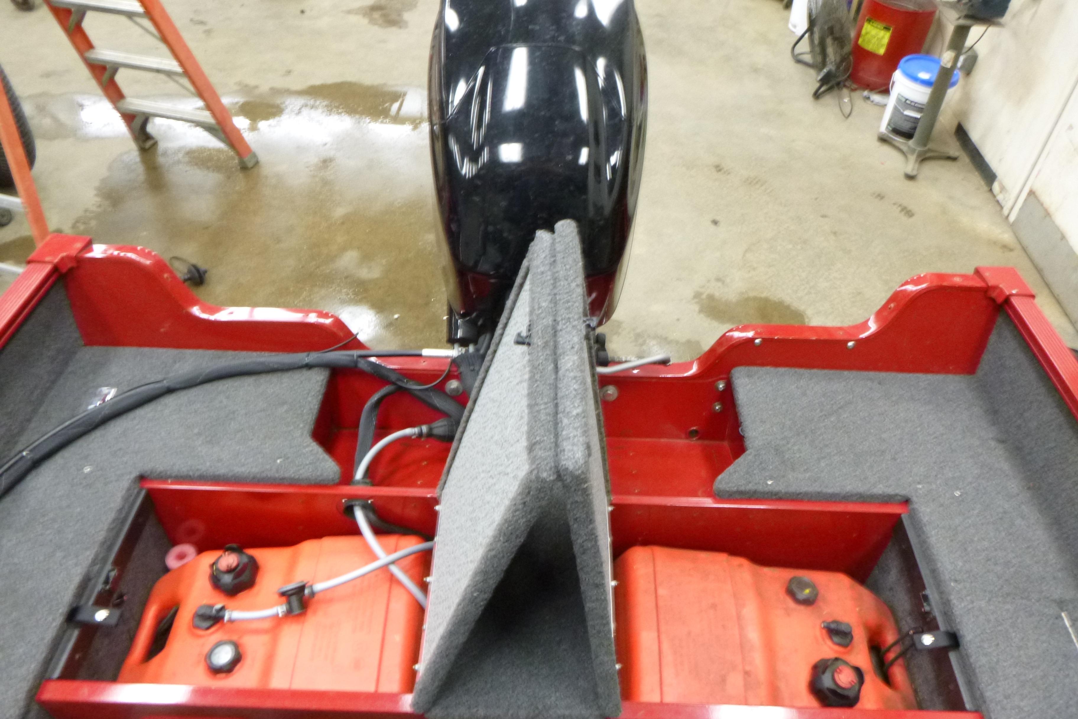 2022 Lund 1650 Angler Sport boat interior with fuel tanks and motor.