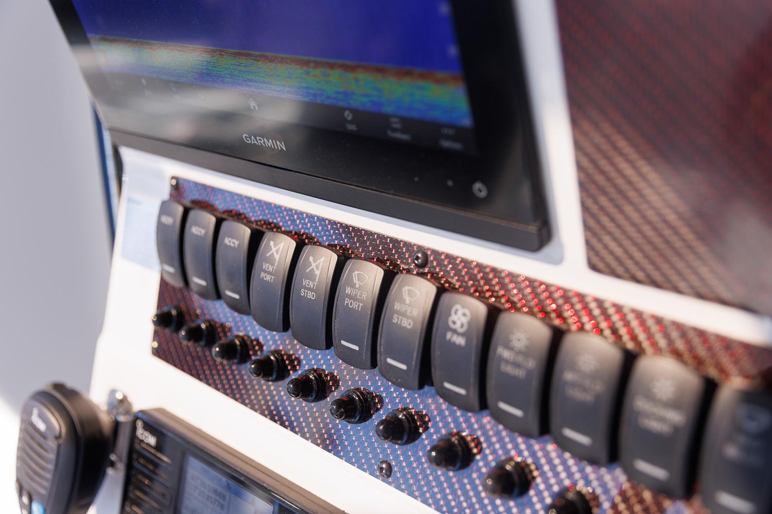 Control panel of 2025 Solara S-310 CW with switches and Garmin display.