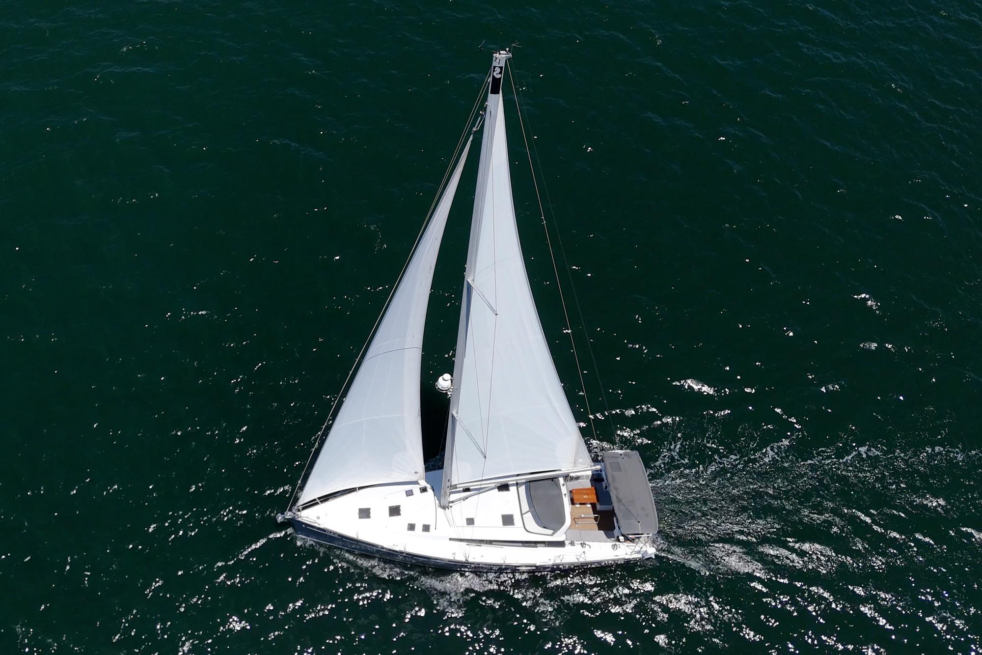 Aerial view of 2017 Beneteau Sense 50 sailboat navigating open waters.