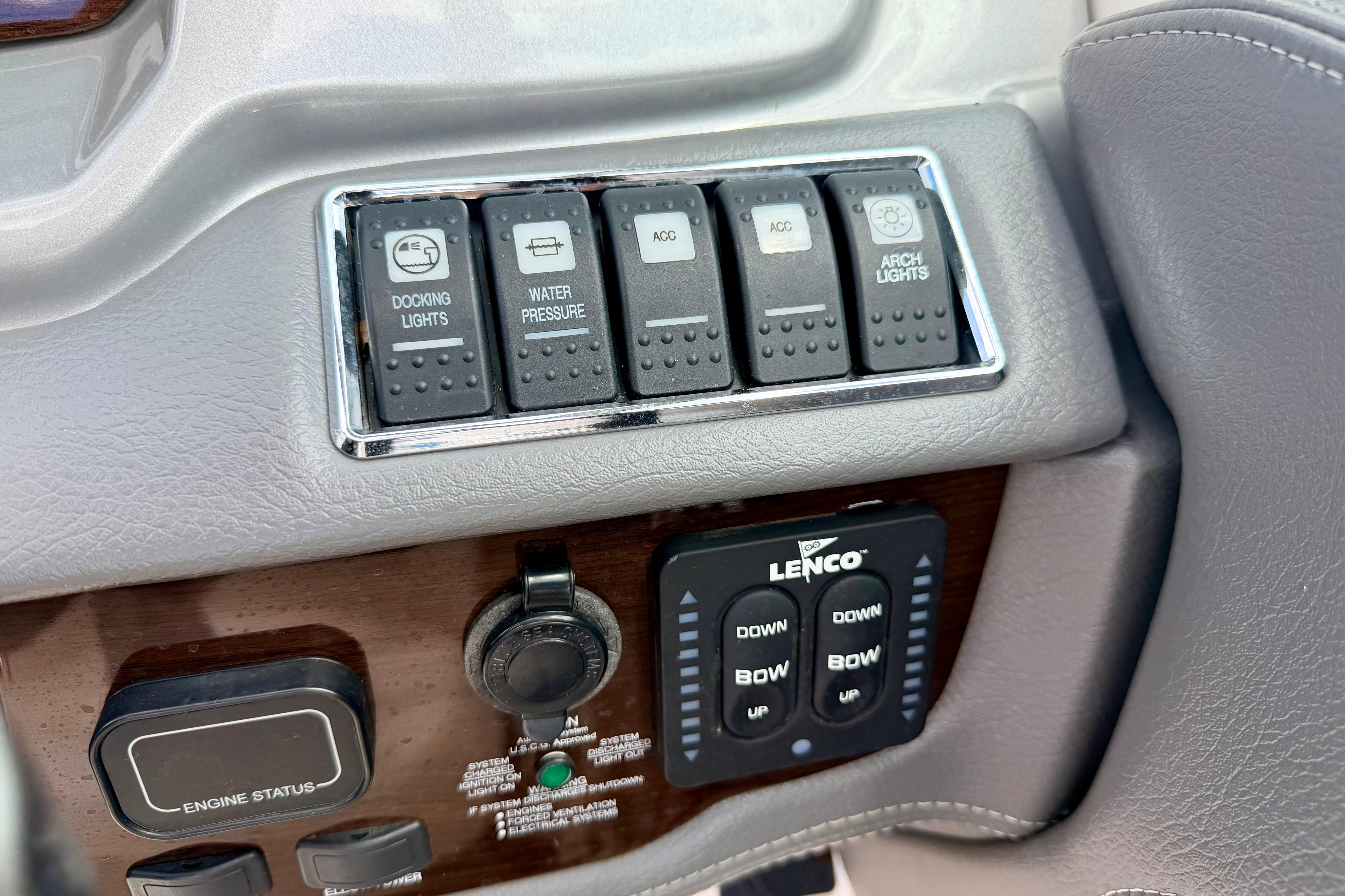 Control panel of a 2015 Chaparral Sunesta 264 boat with switches and Lenco controls.