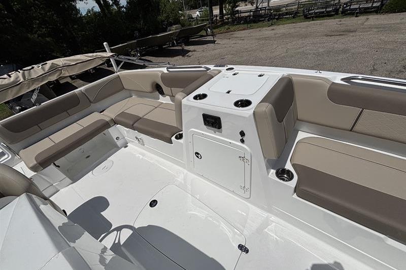 2026 Tahoe 2150 boat interior with beige seating and storage compartments.