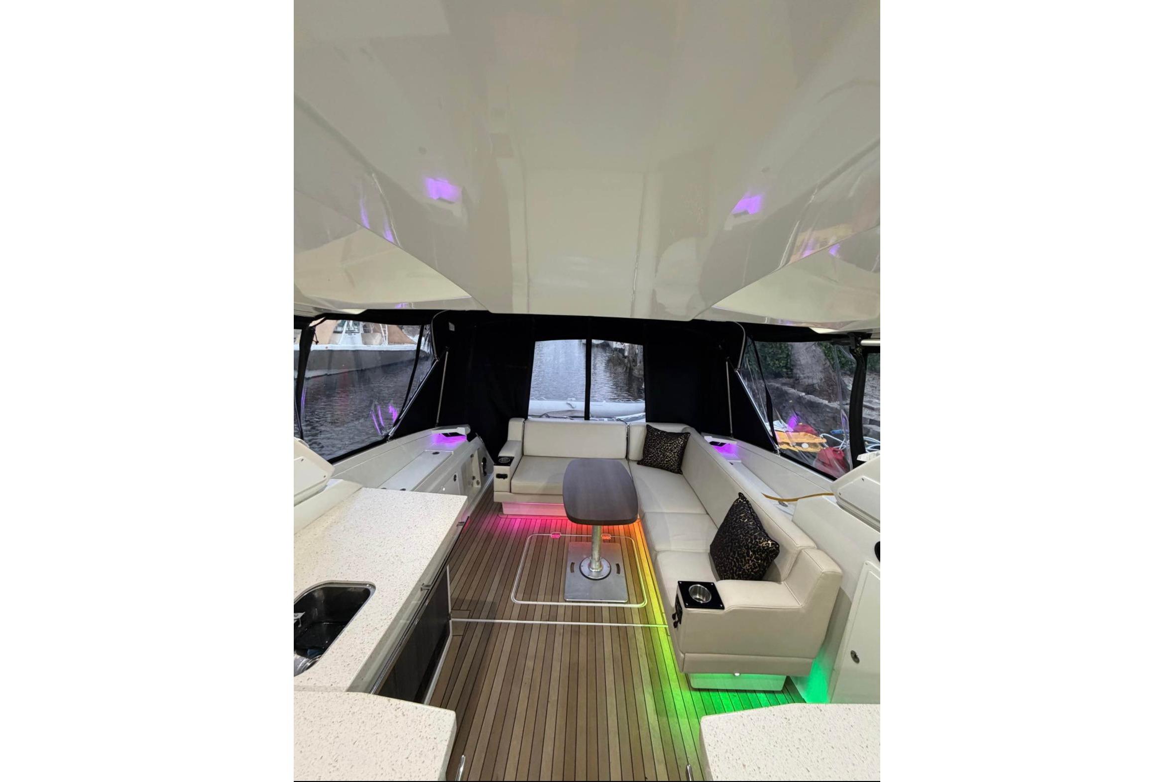 Luxurious interior of 2015 Monterey 360 Sport Coupe with ambient lighting and plush seating.