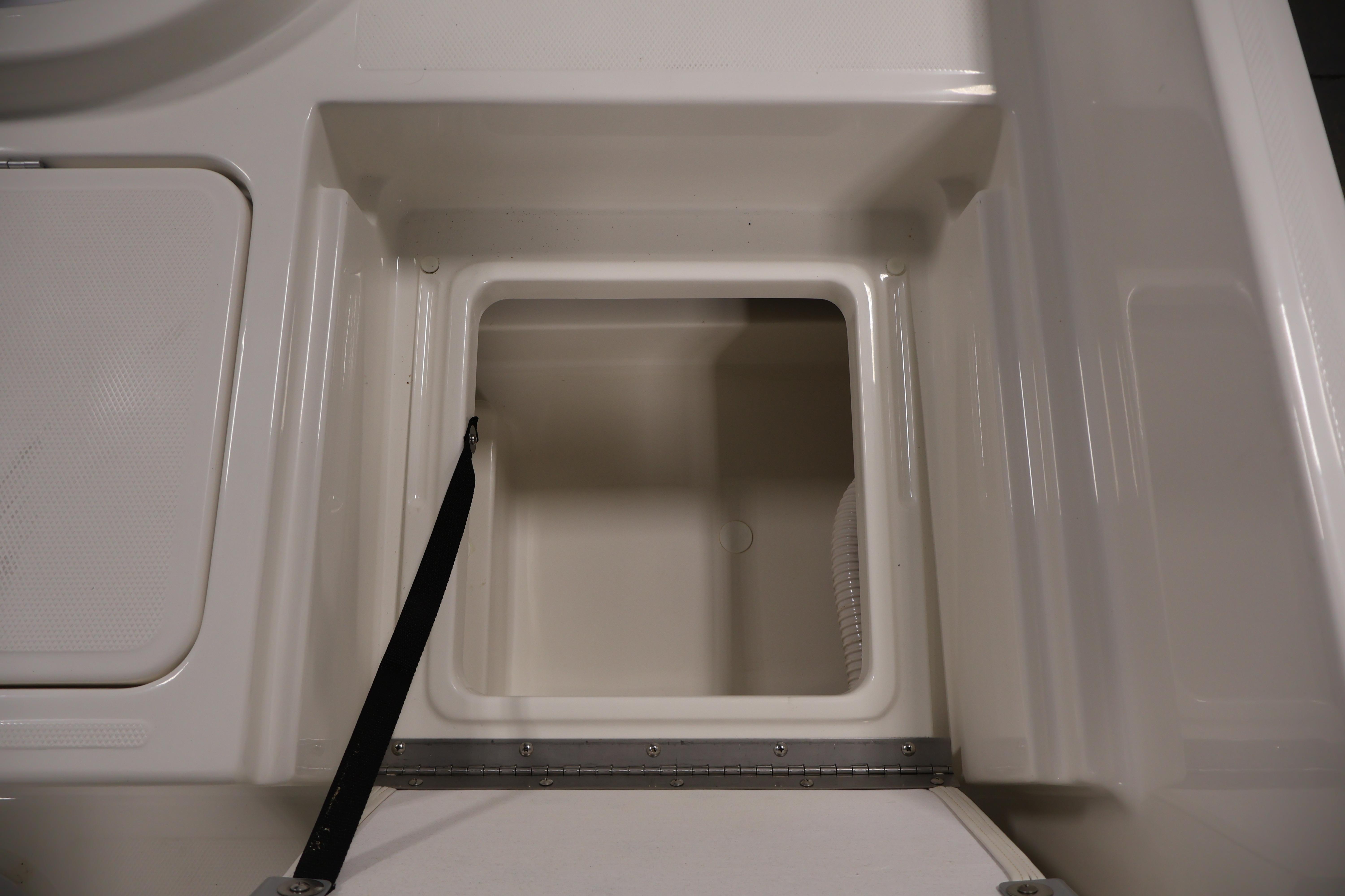Storage compartment of 2026 Bayliner Trophy T18 boat, featuring a clean, white interior.