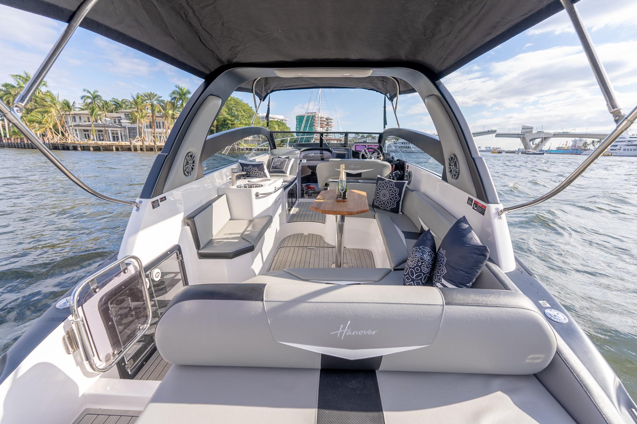 Luxurious 2027 Hanover 305 yacht interior with elegant seating and scenic waterfront view.