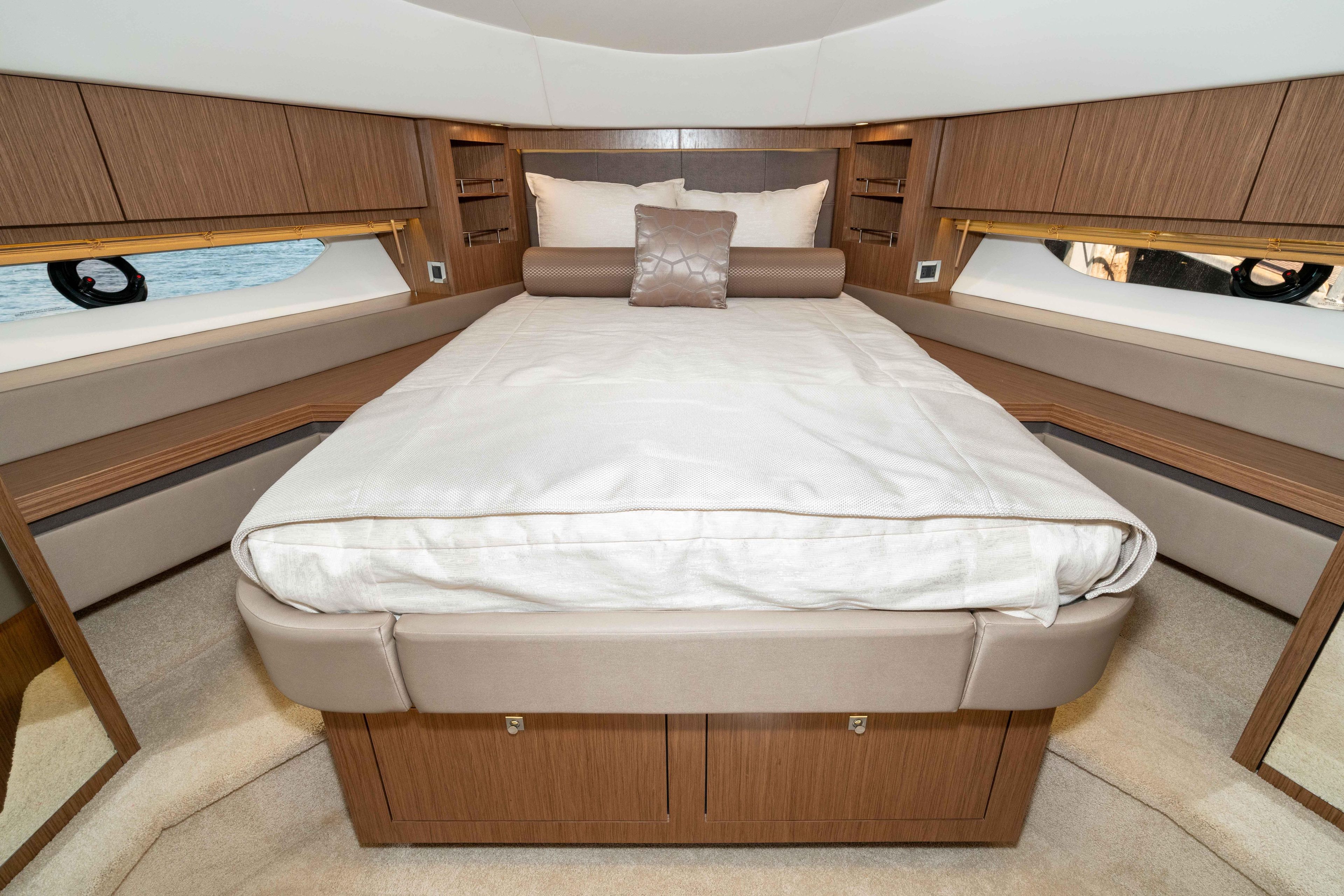 Luxurious 2017 Sea Ray 510 Fly yacht bedroom with elegant wood finishes and plush bedding.