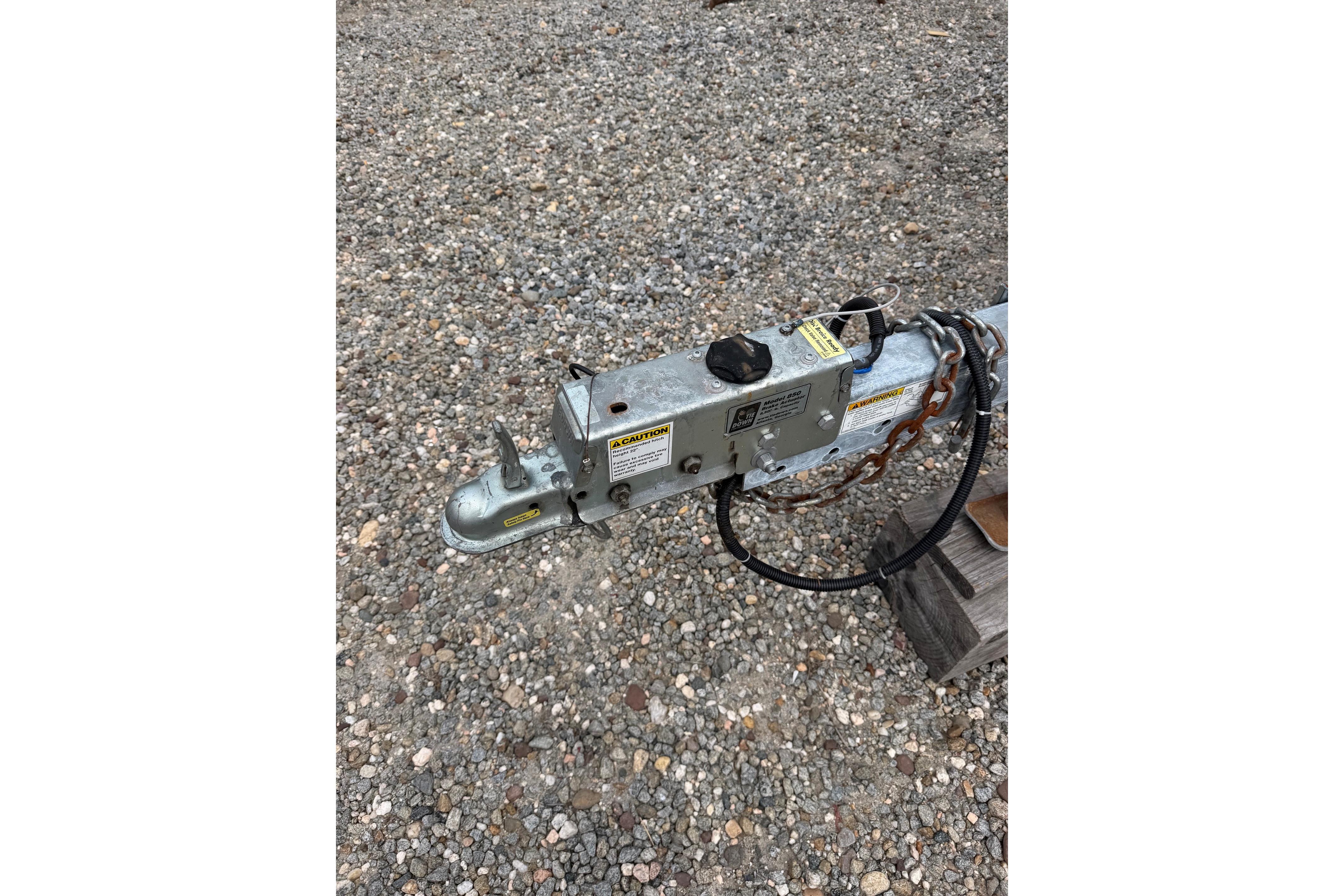 Trailer hitch for 2000 Sea Ray 240 Sundancer on gravel surface.