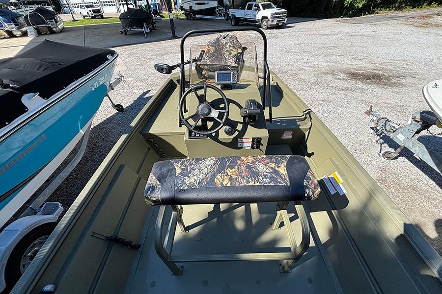 2022 Lowe Roughneck 1660 boat interior with steering wheel and camouflage seating.
