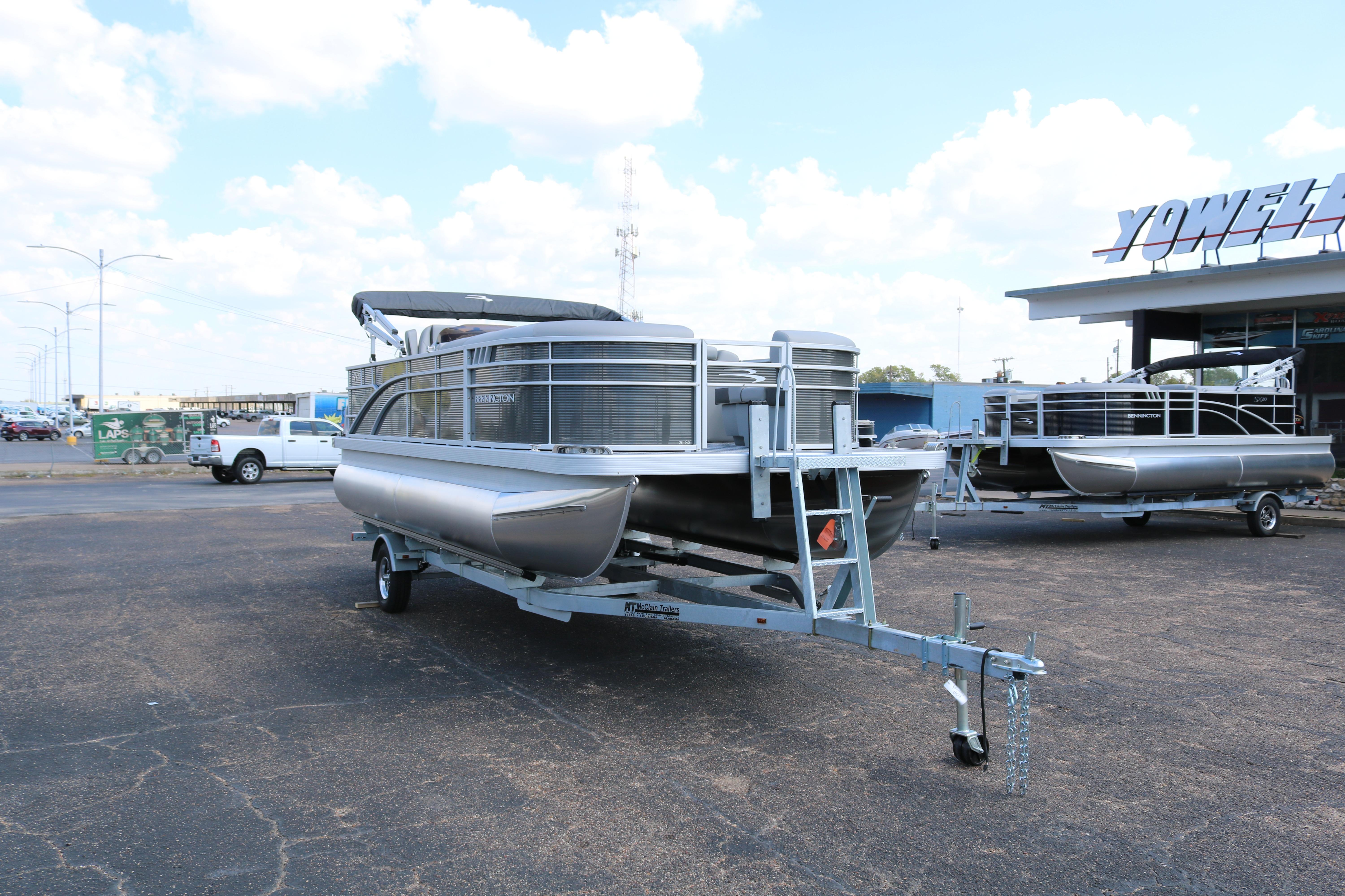 2026 Bennington 20SXSNP REAR FISH pontoon boat on trailer at dealership.