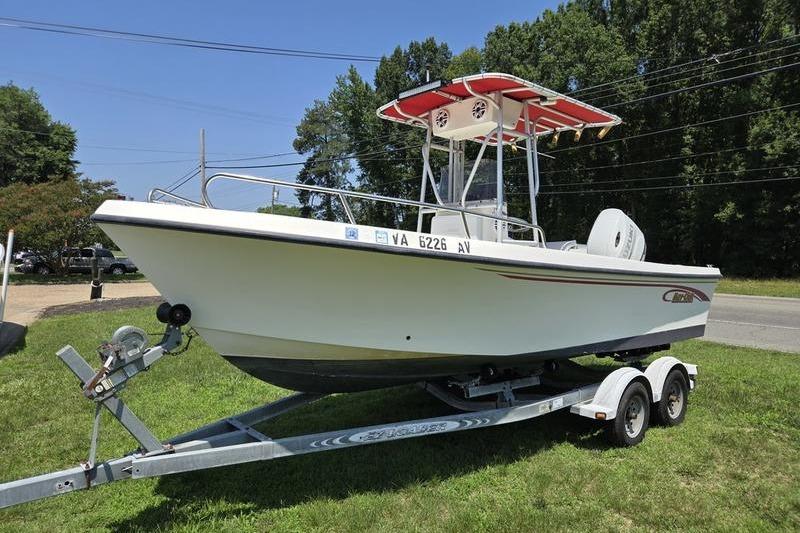 2000 May-Craft 2000CC boat on trailer, parked on grass, sunny day.