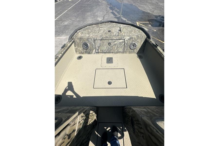 2025 SeaArk Predator 300 AK boat interior with camouflage design and storage compartments.