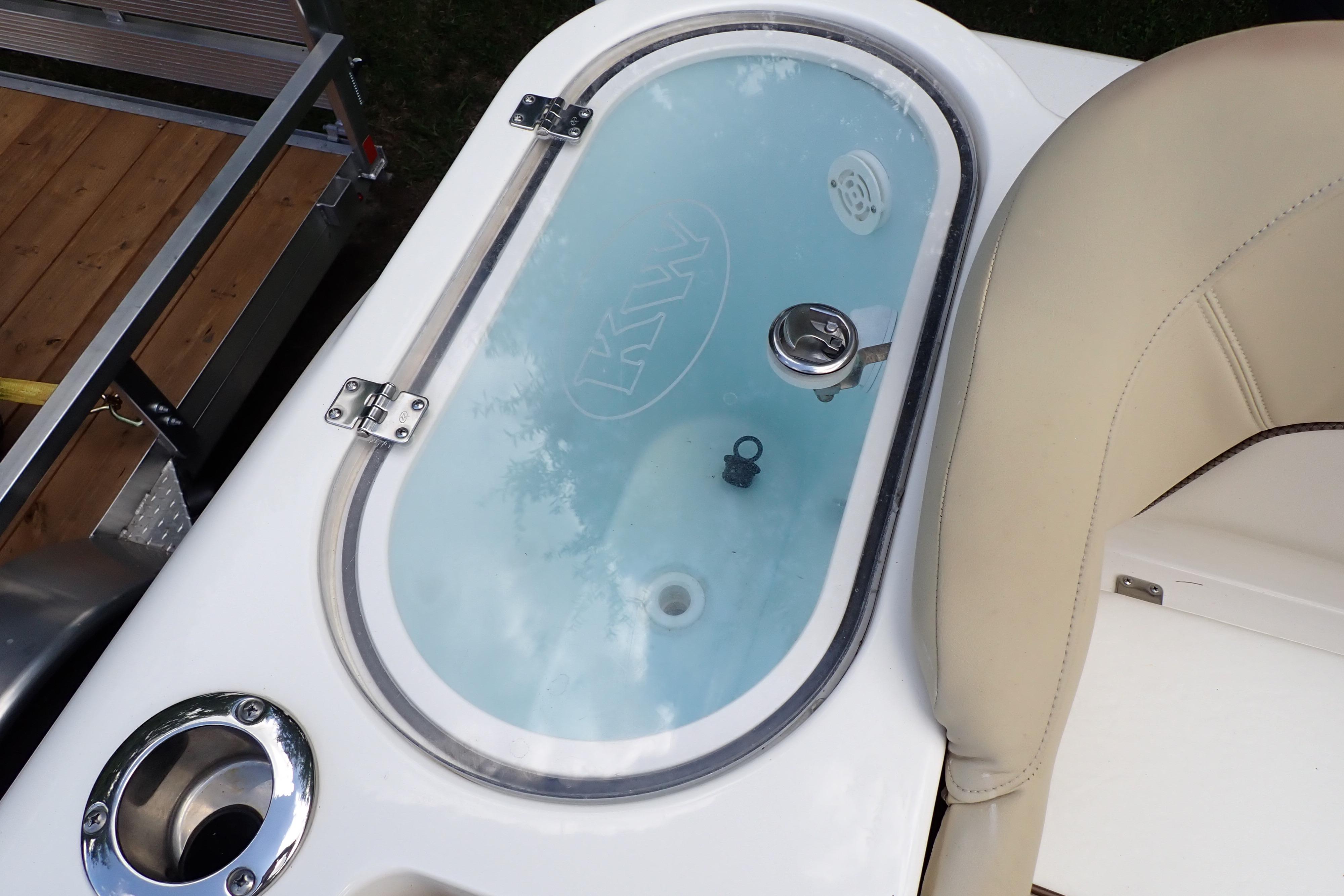 2019 Key West 263 FS boat livewell with clear lid and beige seating.