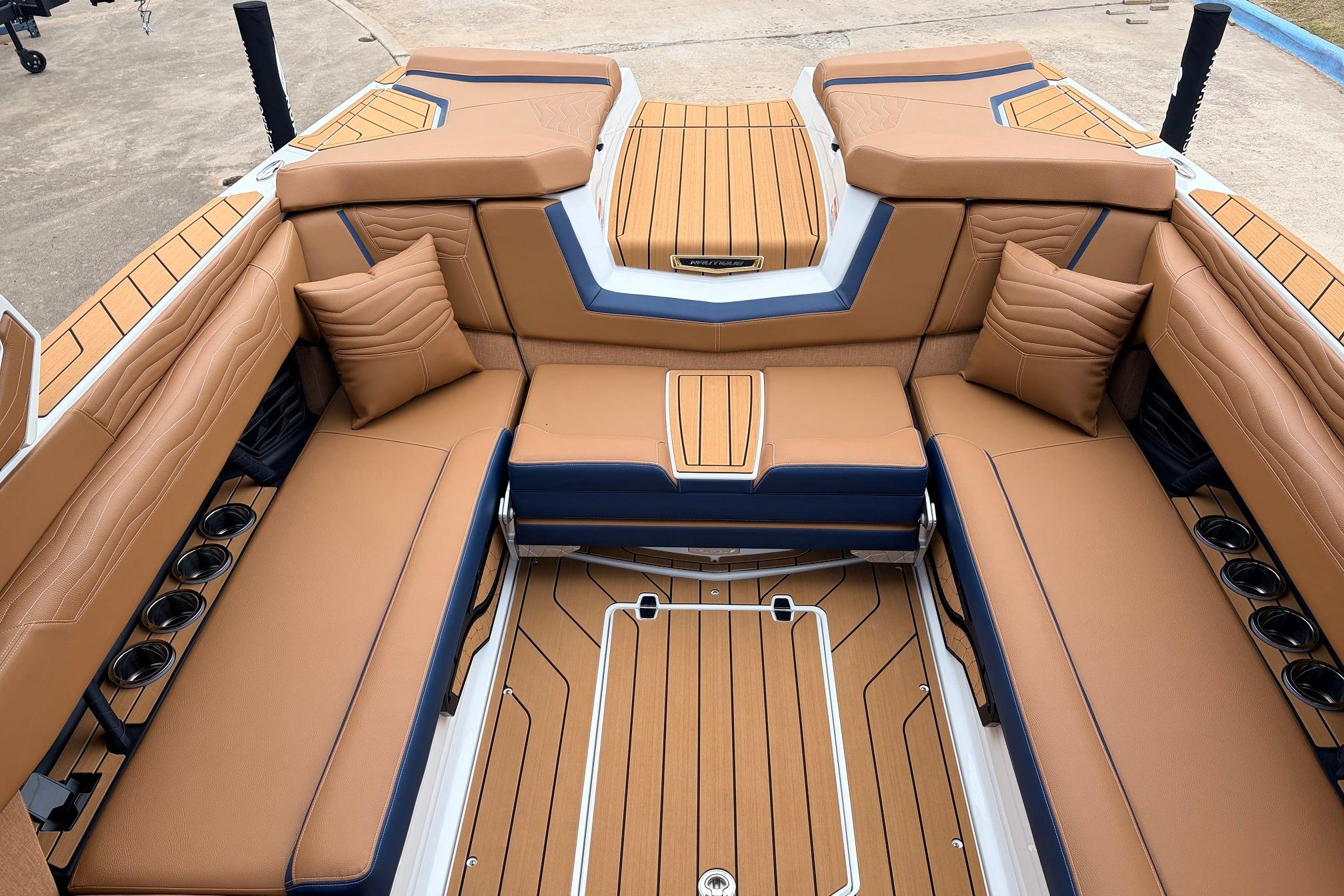 2026 Nautique Super Air Nautique G25 interior with luxurious tan seating and cup holders.