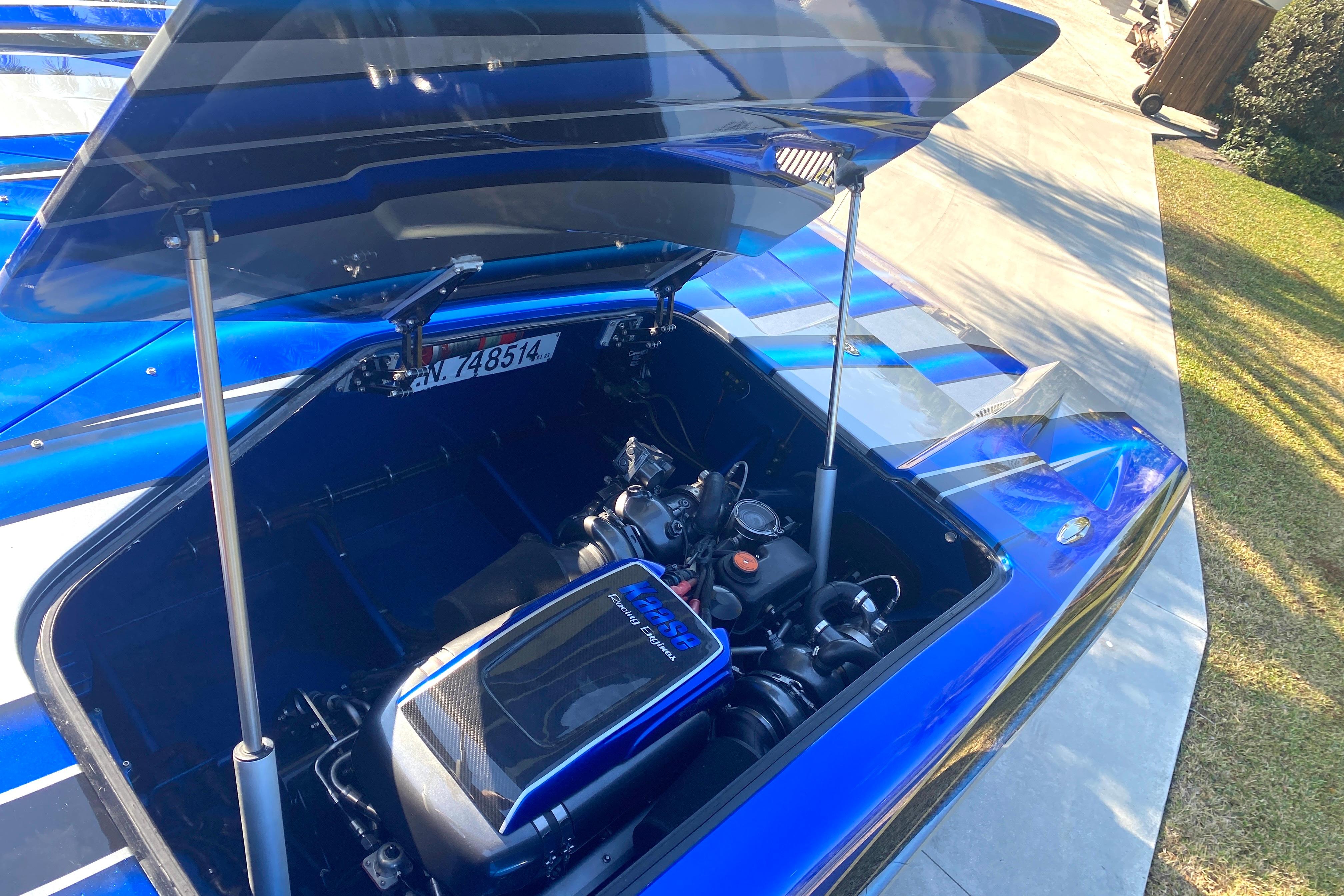 Open engine compartment of a 2016 MTI 44 RP boat, showcasing powerful engine components.