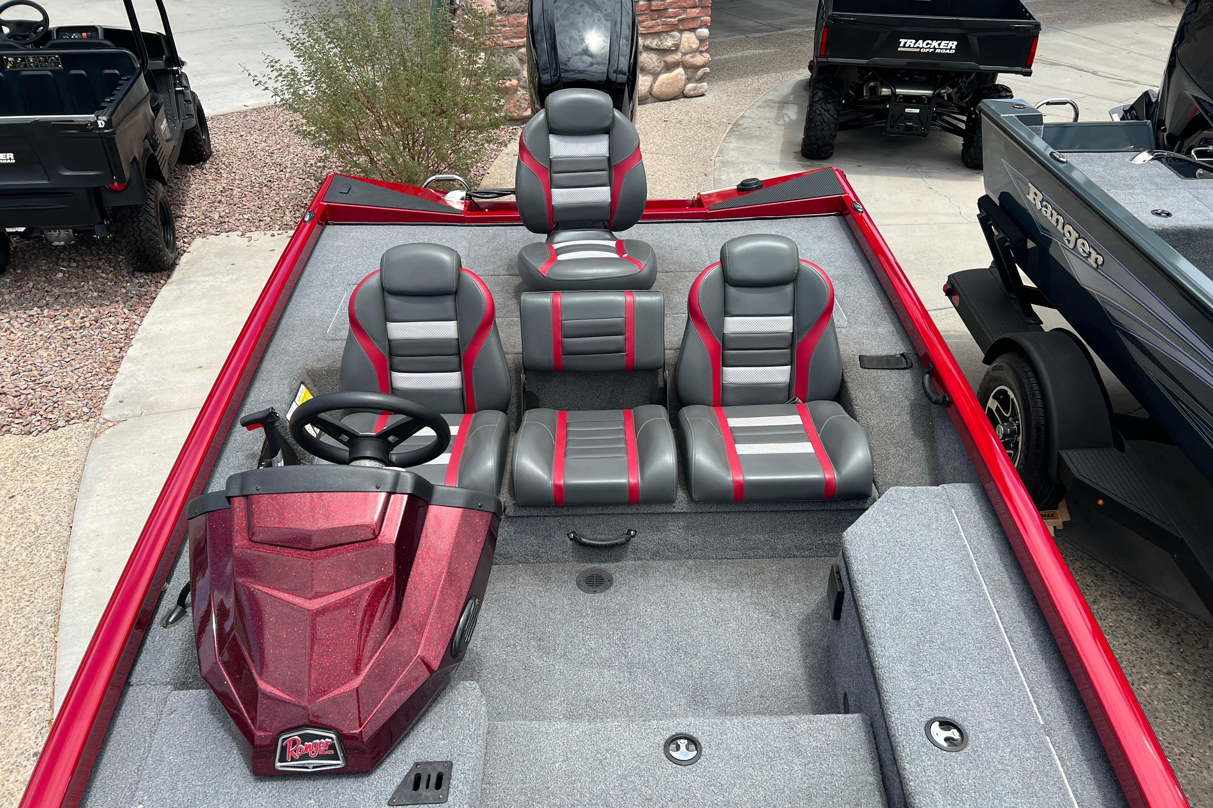 2026 Ranger RT178 boat interior with red and gray seating, steering wheel, and dashboard.
