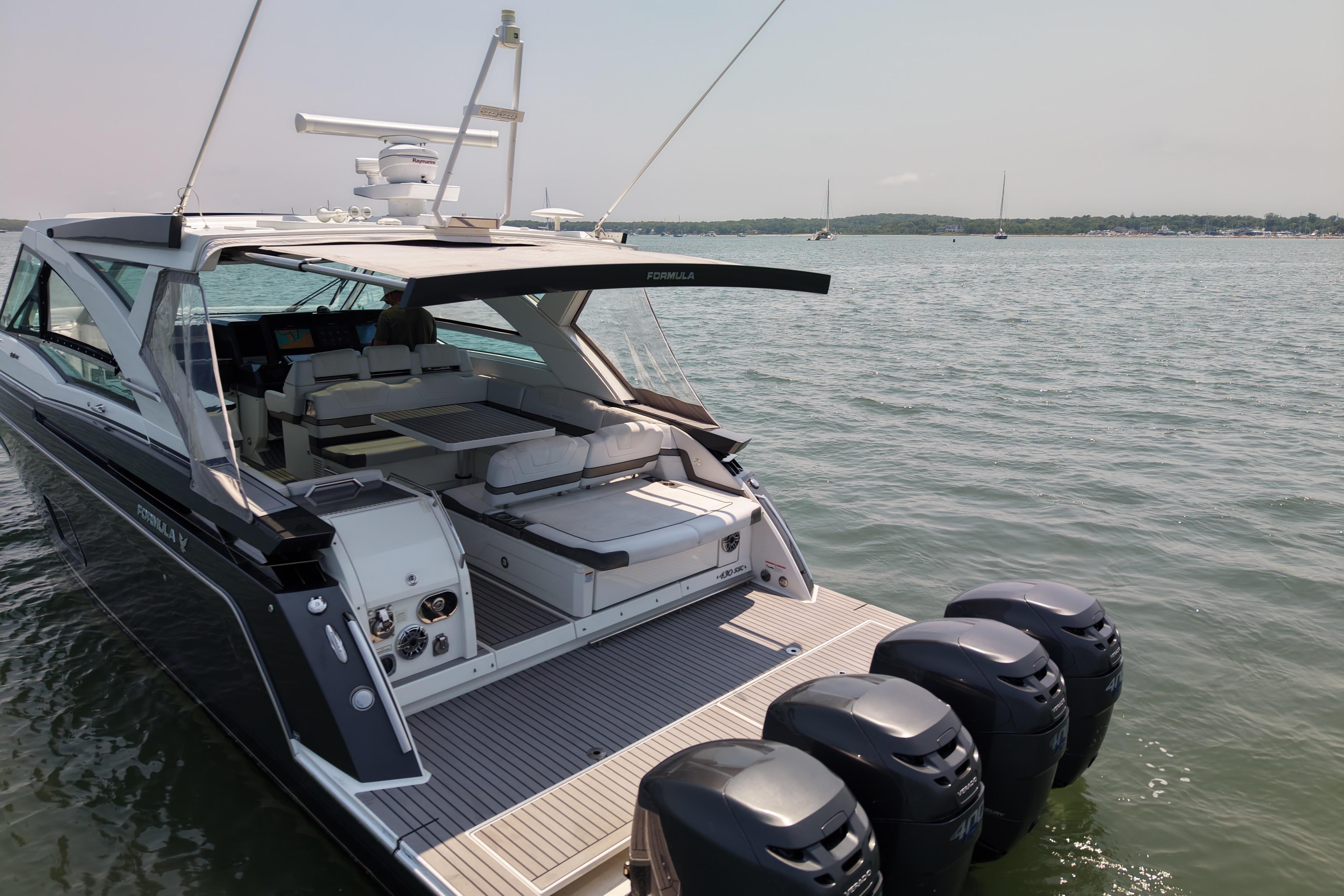 2019 Formula 430 Super Sport Crossover yacht on calm water with multiple outboard engines.