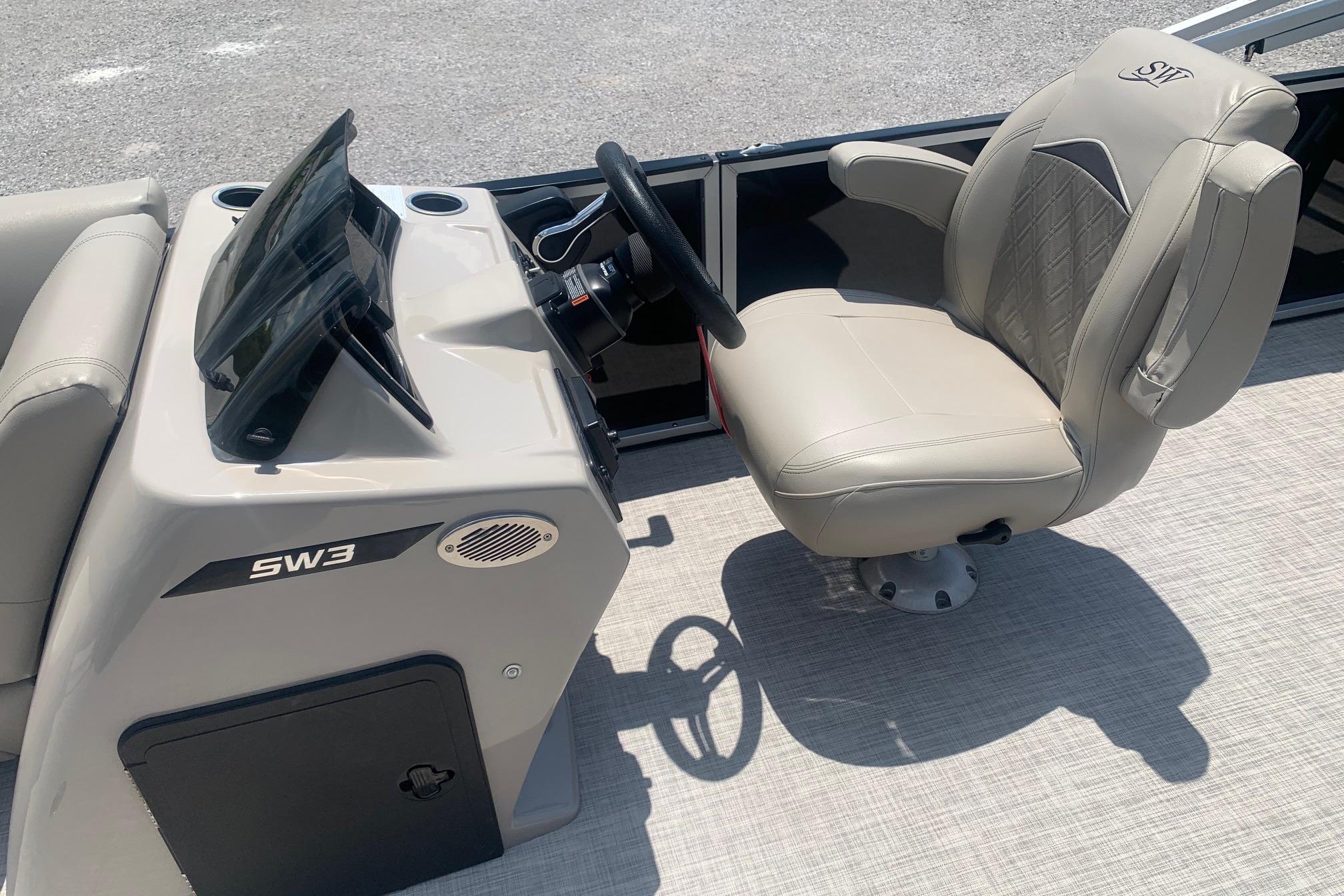 2023 Silver Wave 2410 SW3 CLS boat helm with beige captain's chair and steering console.