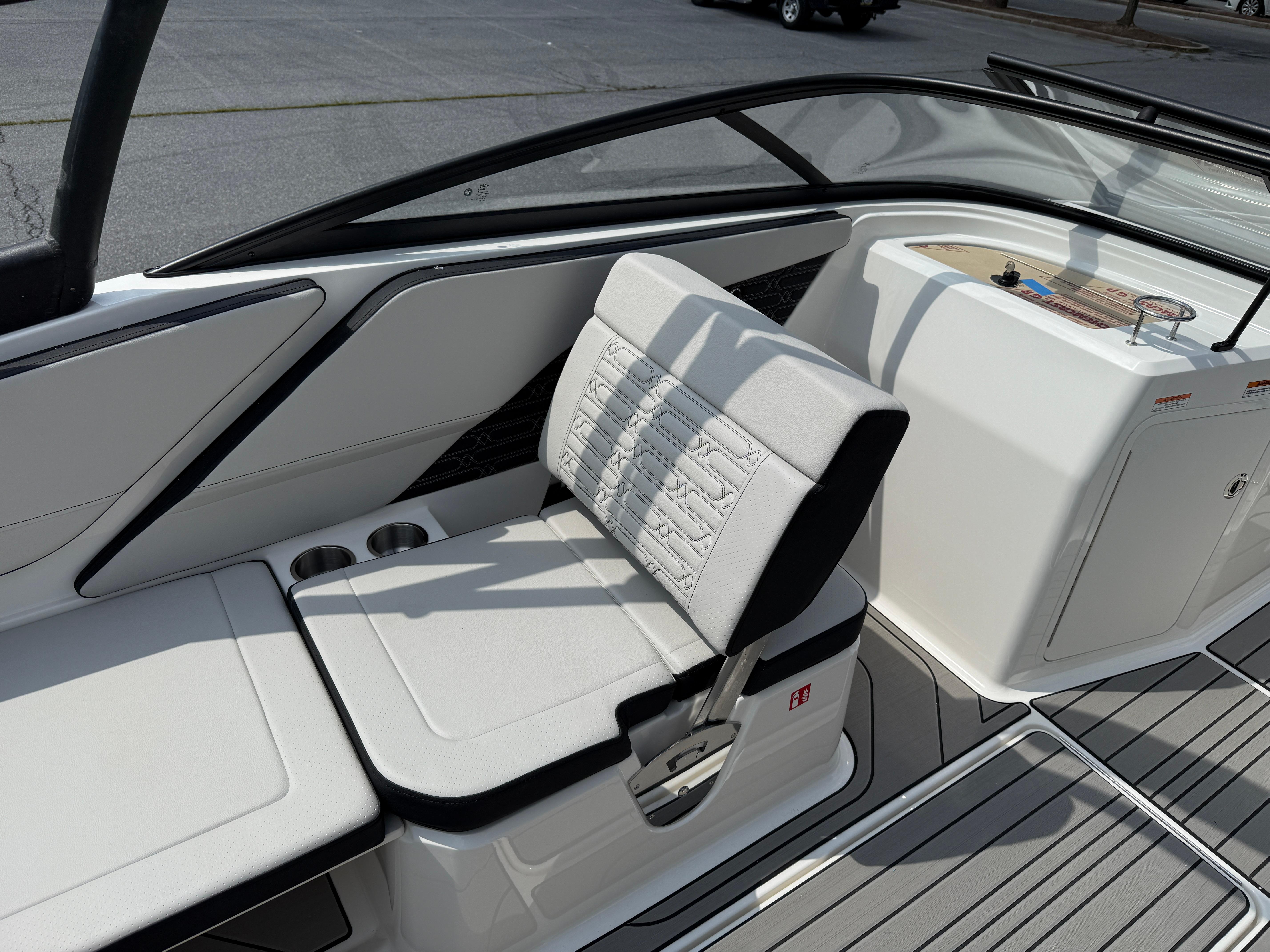2026 Sea Ray SPX 210 Outboard boat interior with white seating and cup holders.